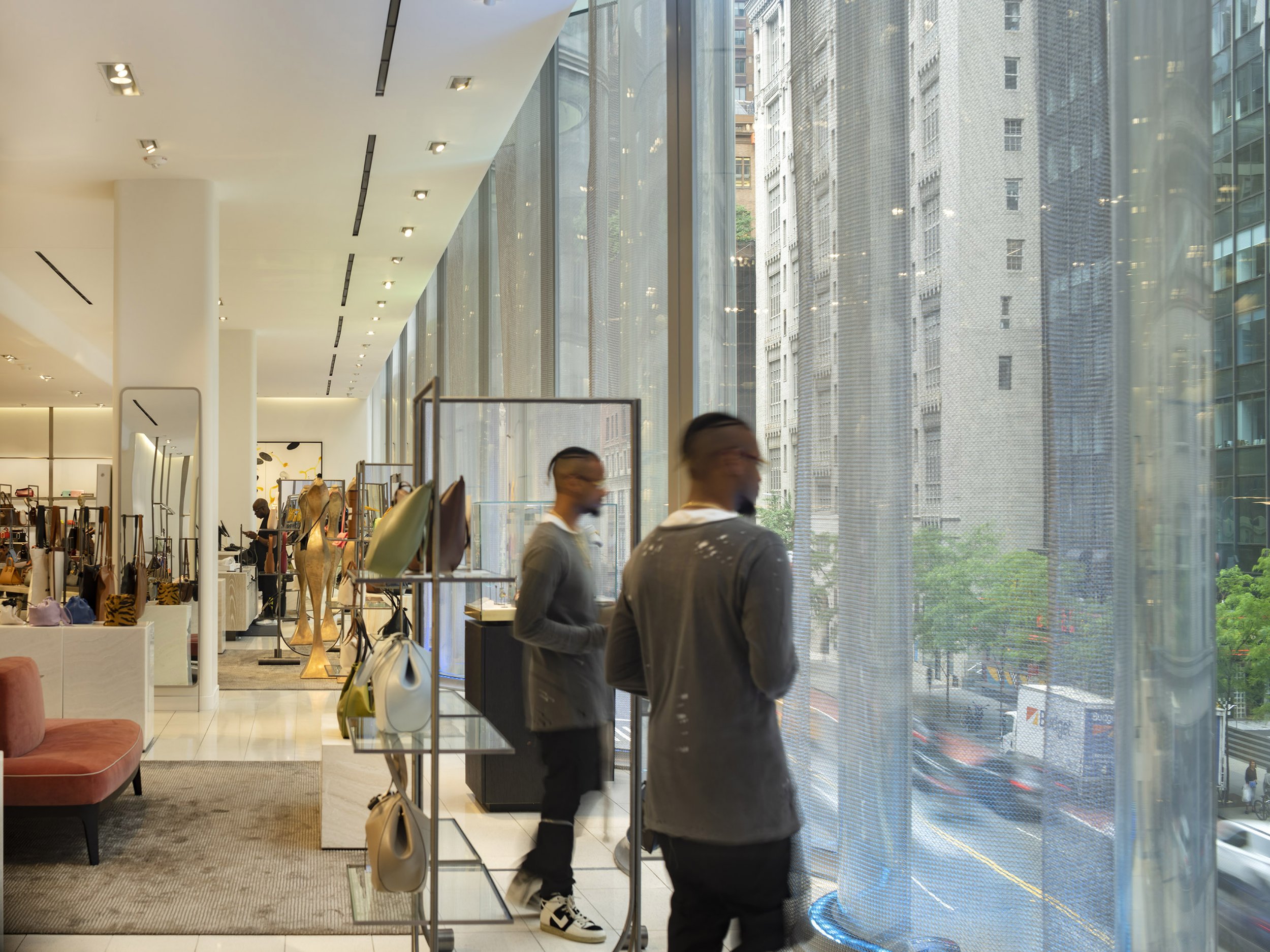 View of the sales floor but also view of street below from floor to ceiling windows
