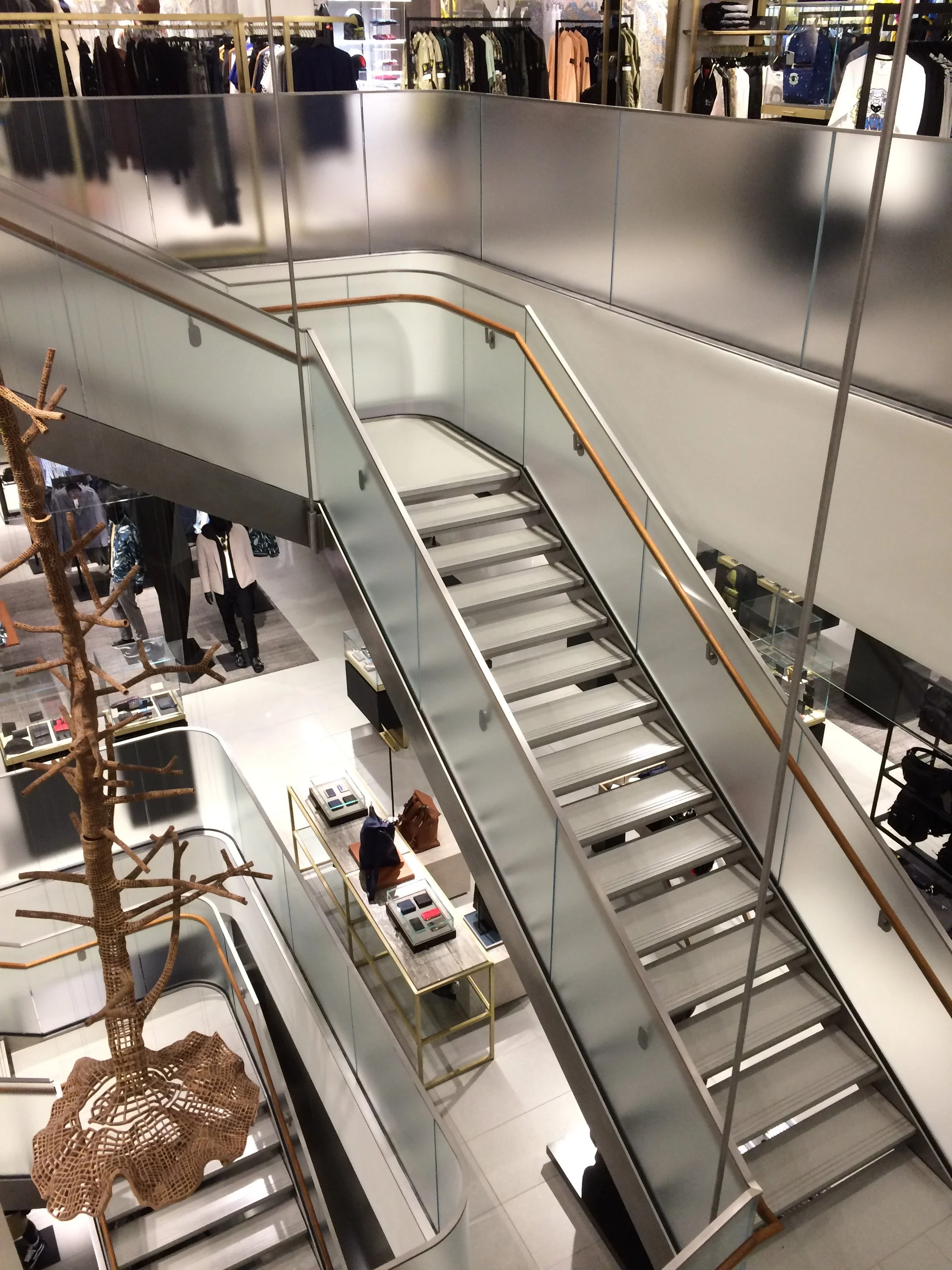 second floor looking down with a hung staircase and diffuse glass