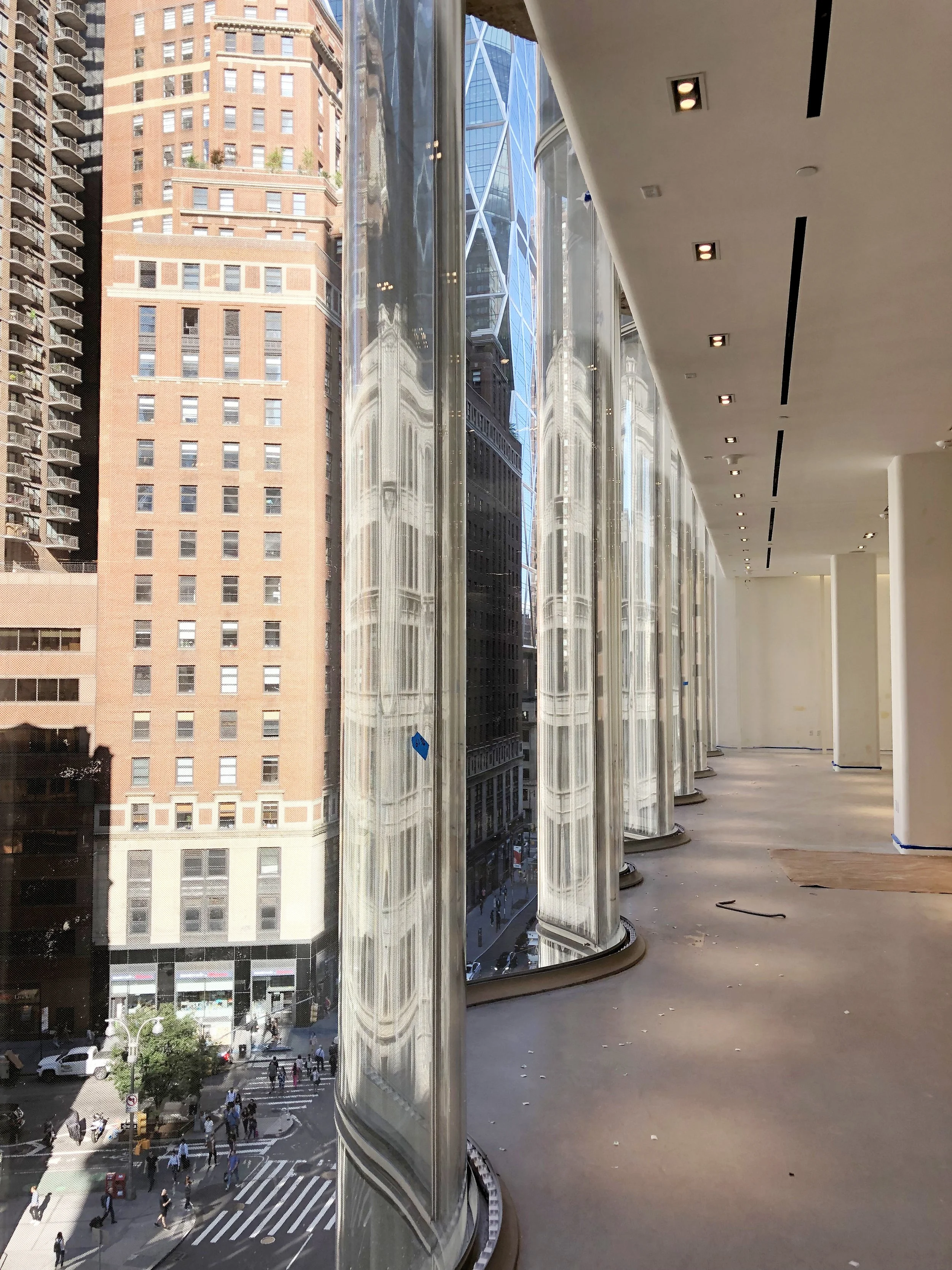 Wave facade under construction looking west with building reflections visible on glass