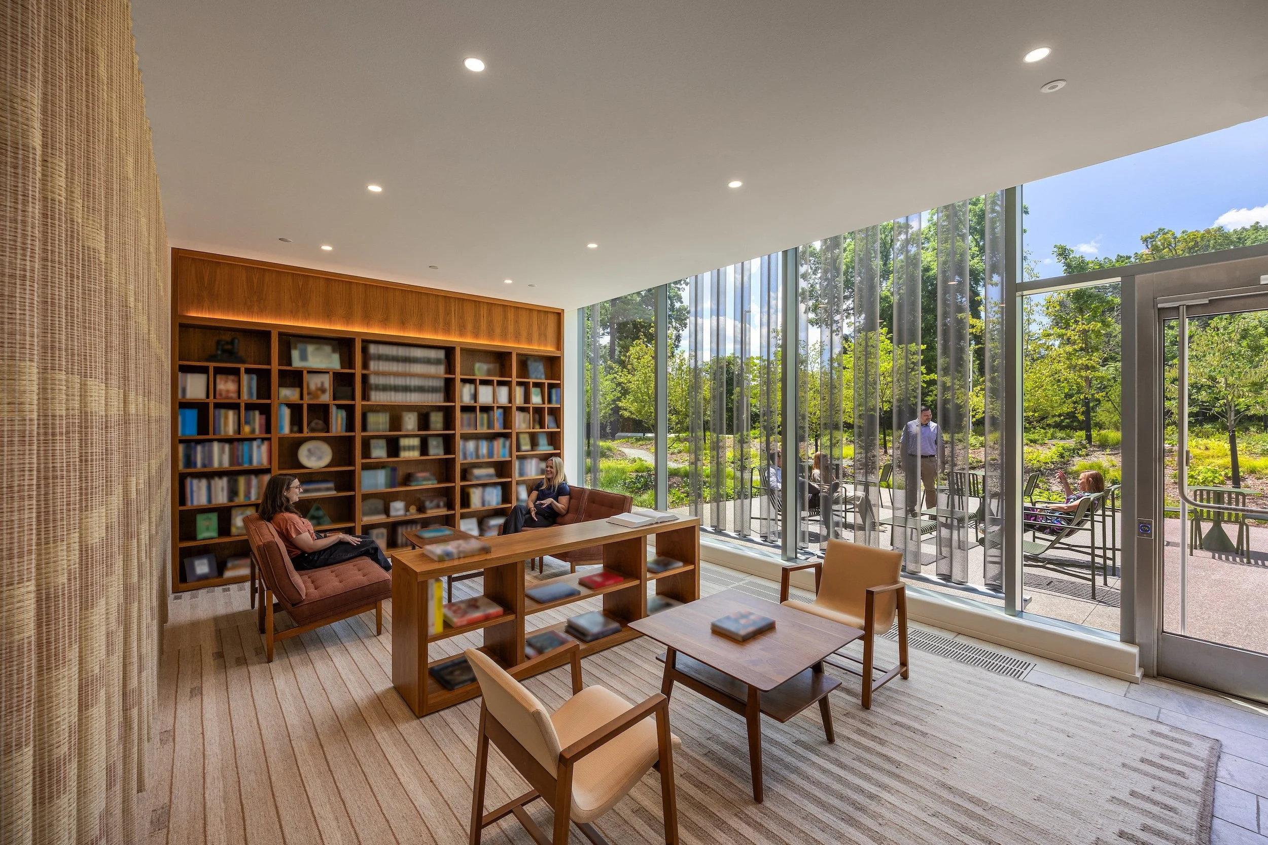 Library interior with view to courtyard outside