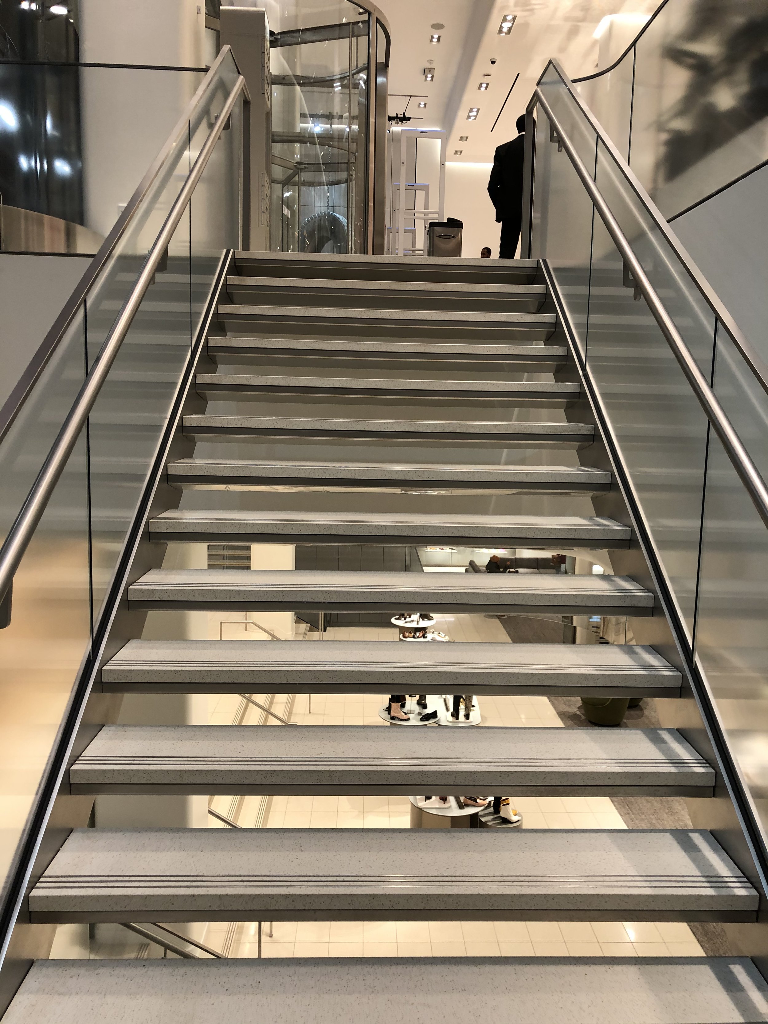 Stairs with a view through them to the floor below
