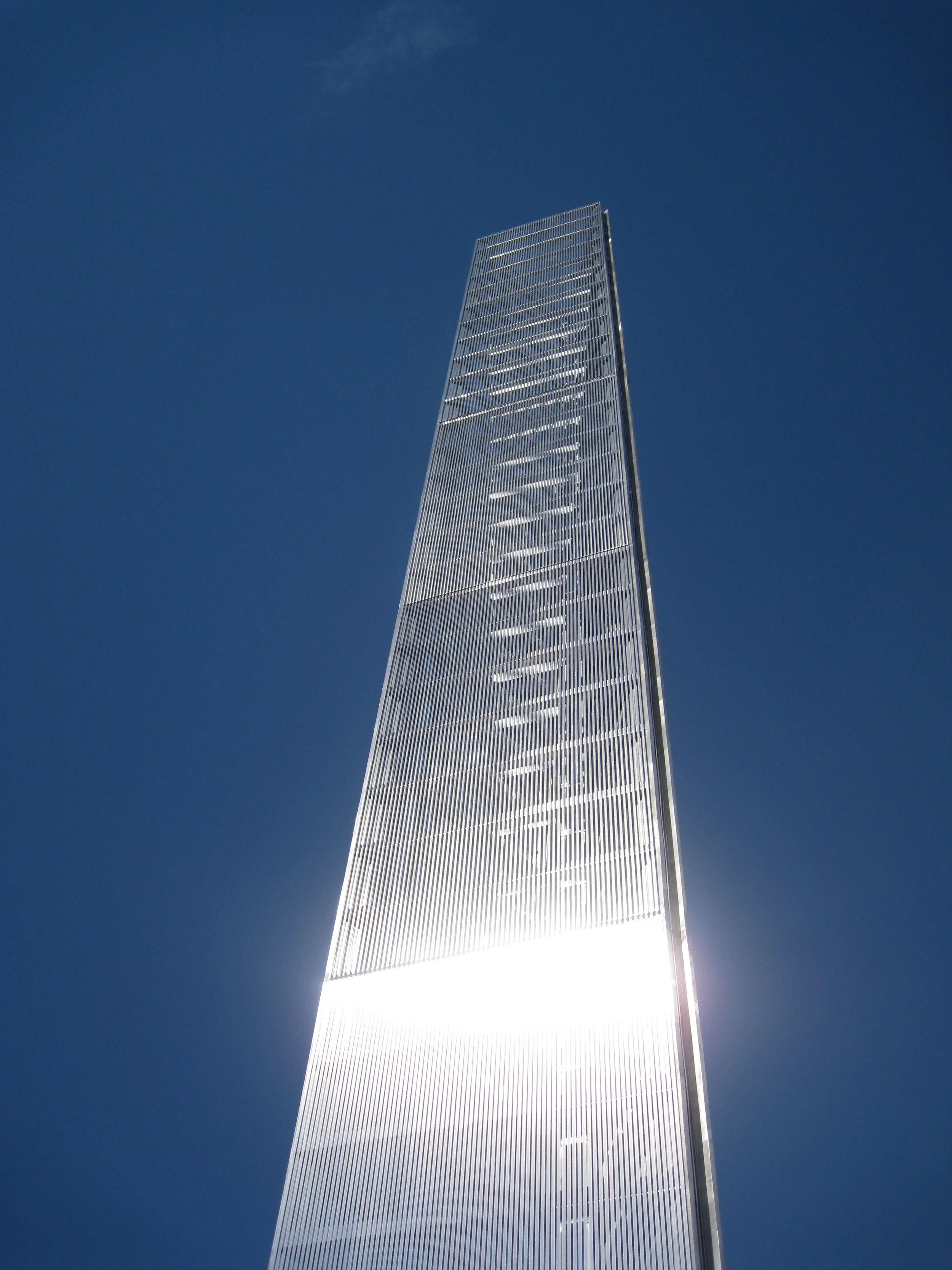 Prismatic Light Pillar with light reflections on its surface.