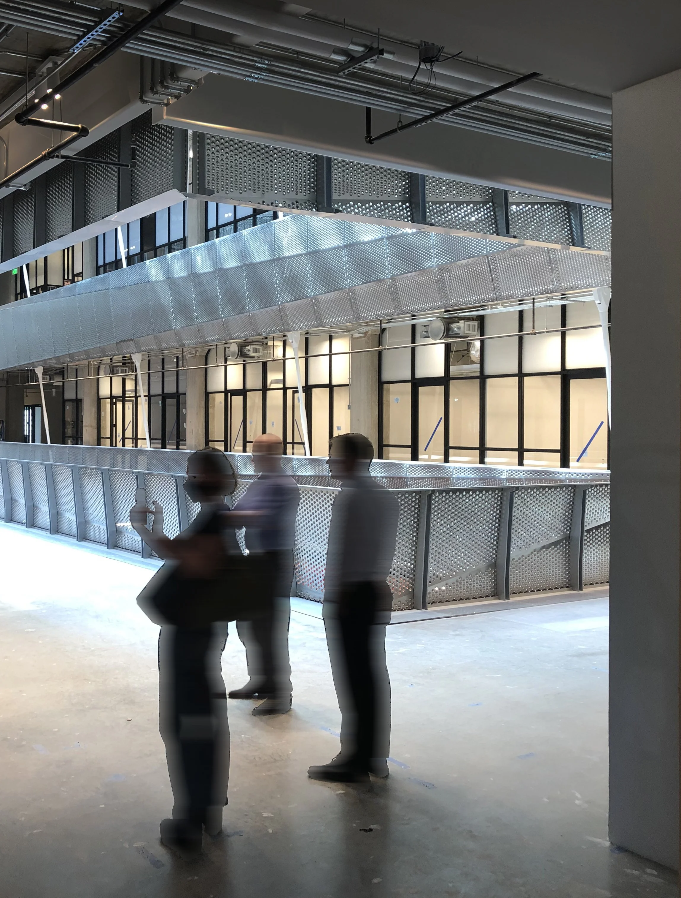 Light cascading through center of building, design team in foreground