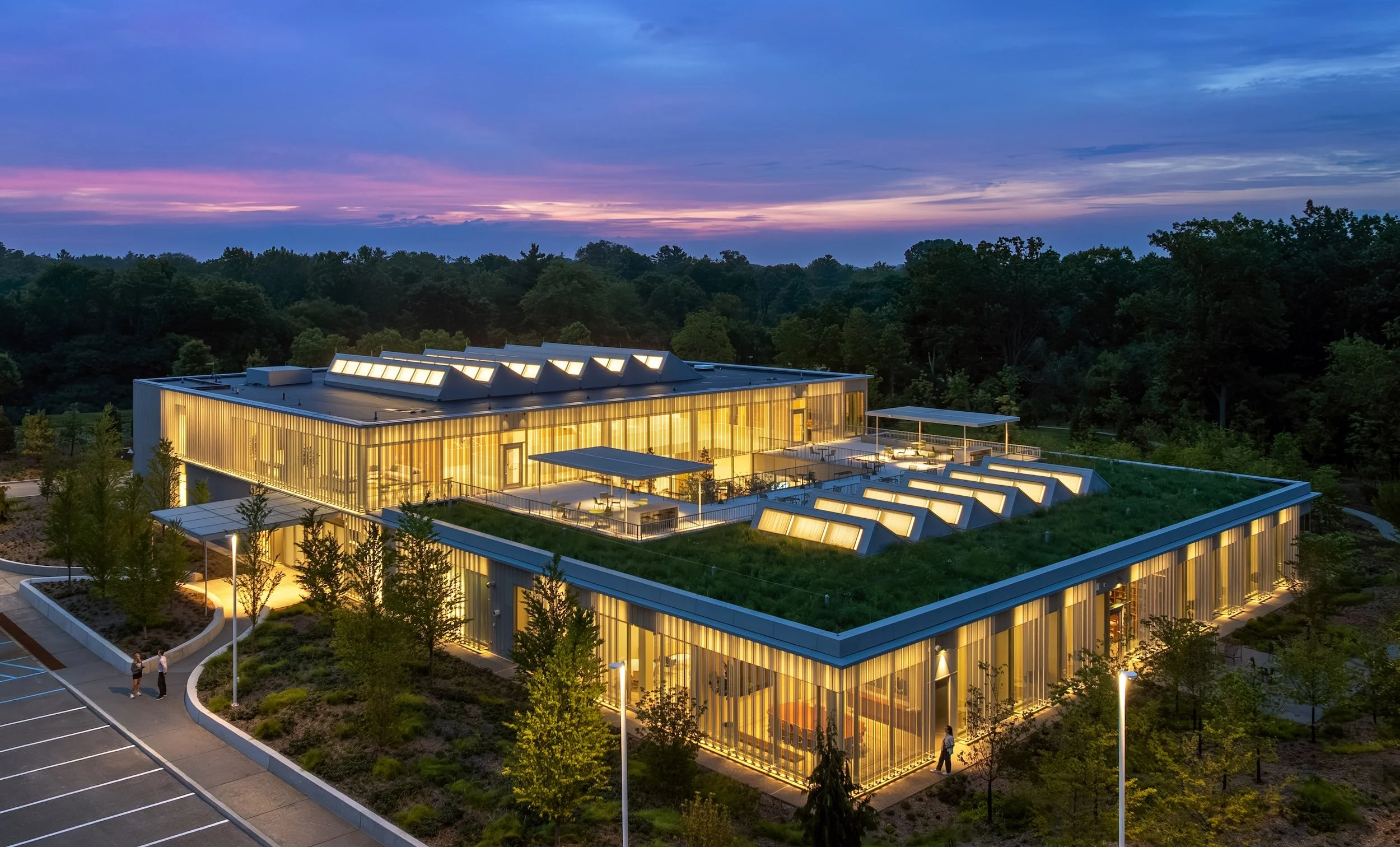 Fully lit building as seen at night with grass roof