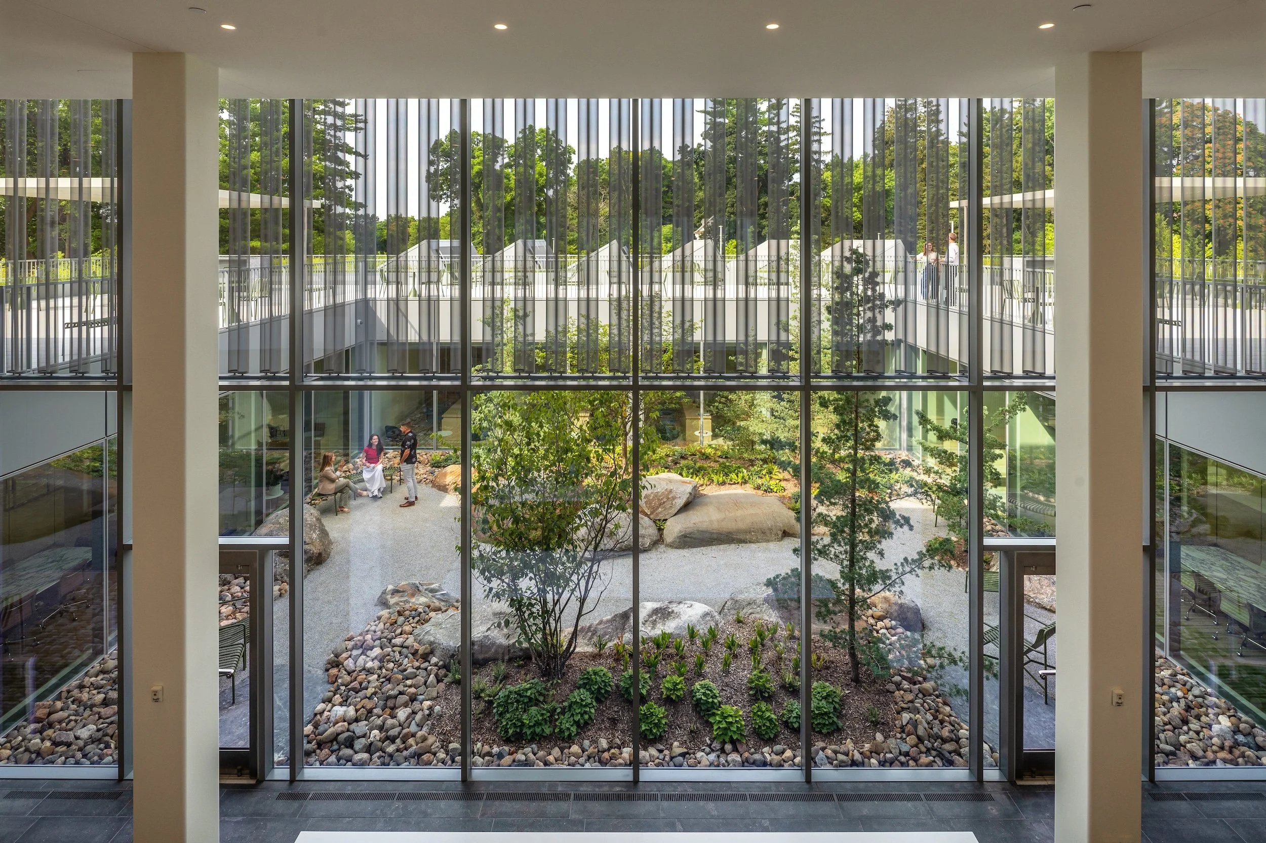 Overlooking the garden with native landscaping from the 2nd floor through floor to ceiling windows
