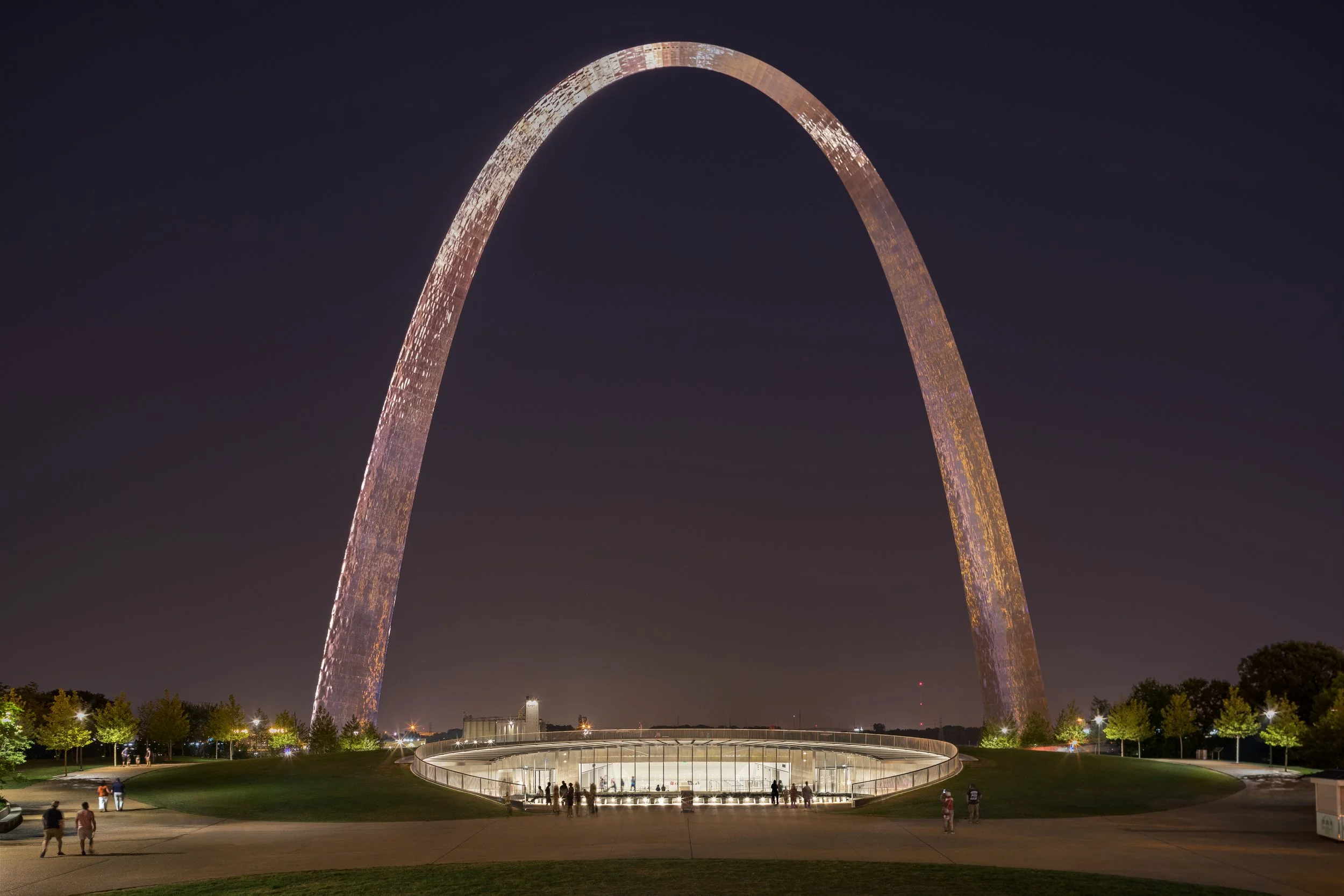 night shot of arch showing entry glow of museum