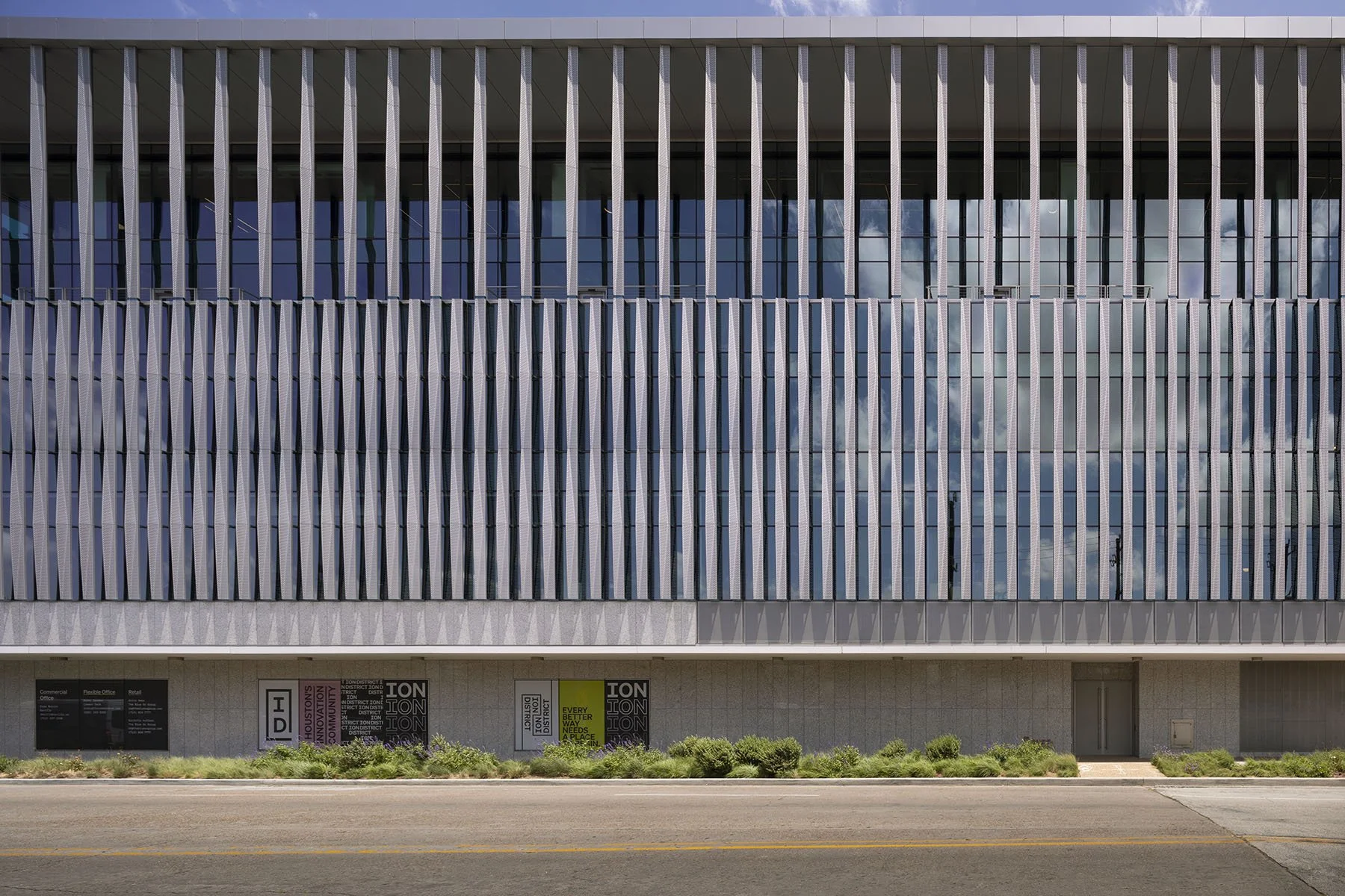 Building as seen from the front with sunscreens and canopy overhang that provide shading
