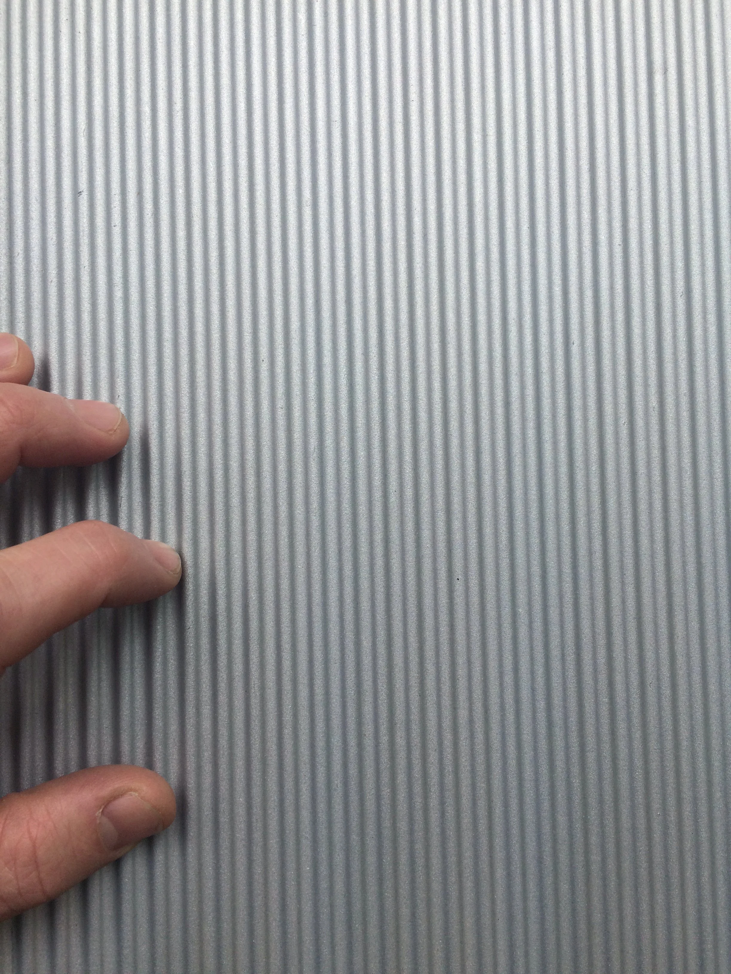 Ribbed aluminum that's a micro pattern of the forms of the facade