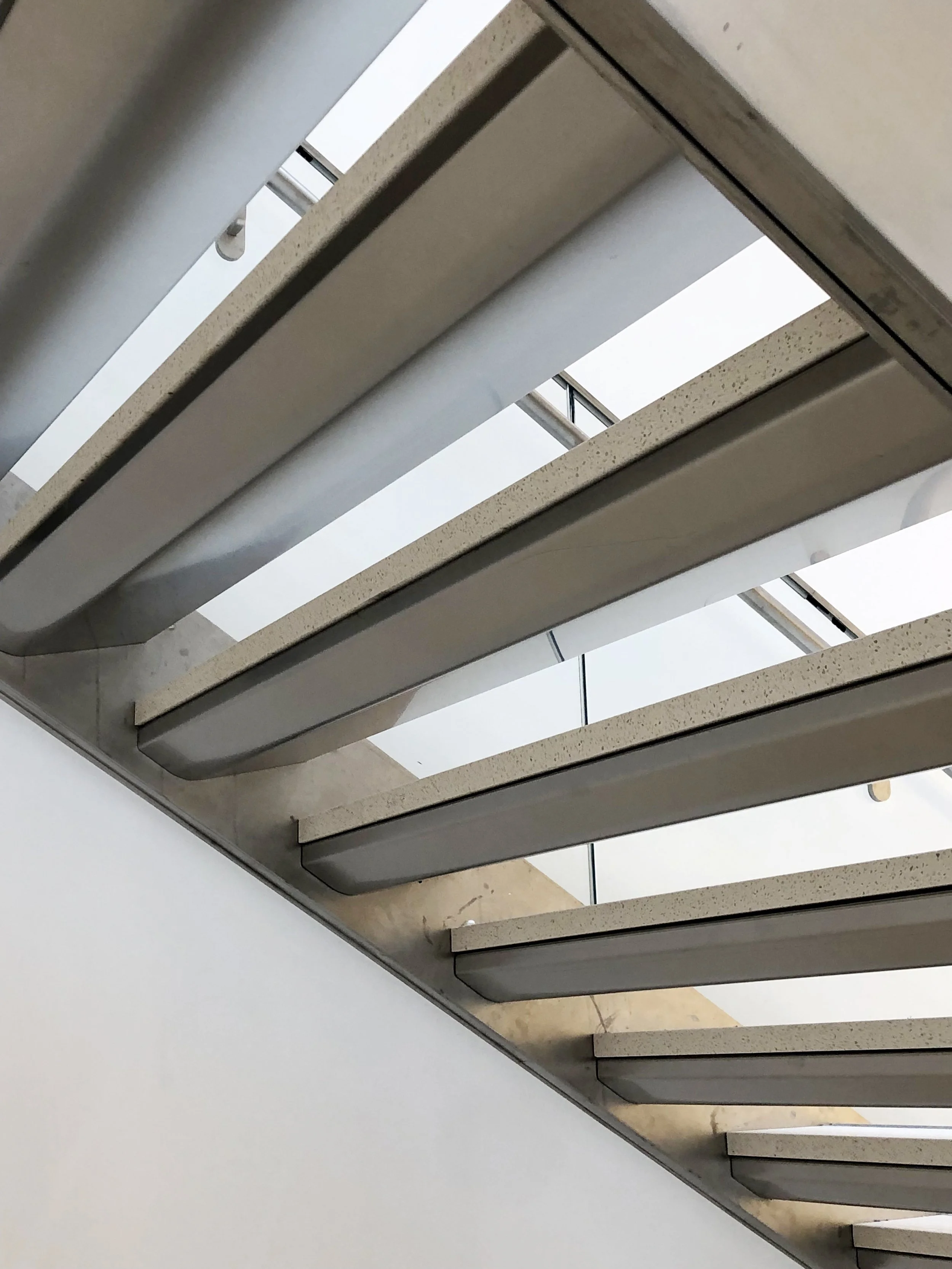 Close of the stairs showing the unique shape and how light reflects underneath