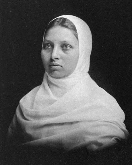 Black and white portrait of a woman with a headscarf.