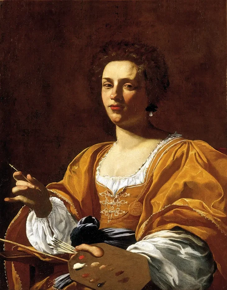 A woman with dark, curly hair wearing a yellow gown with white sleeves, holding a paintbrush and palette, sitting against a dark background.