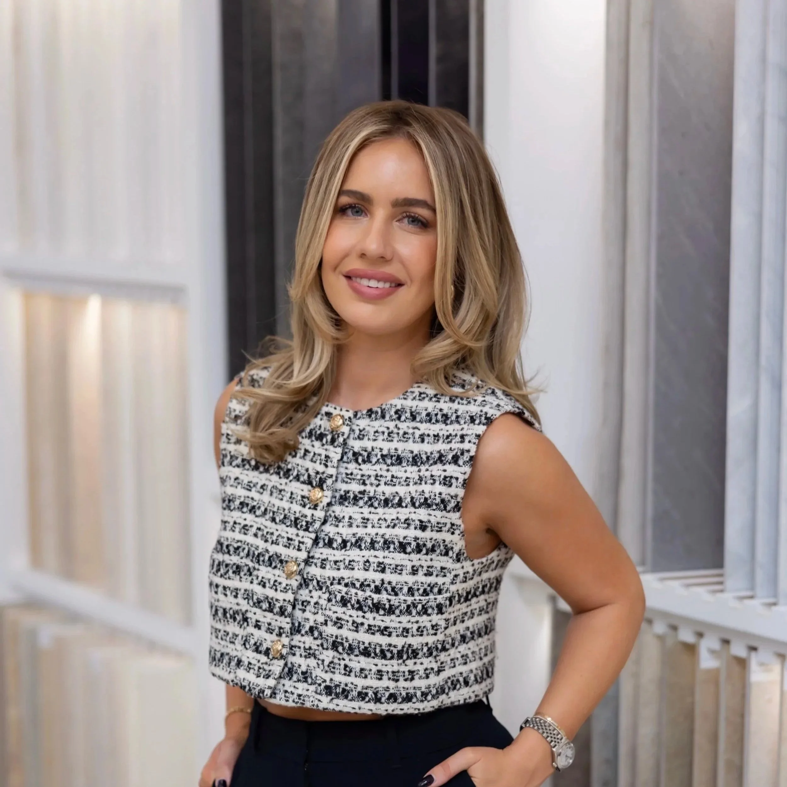 A young woman with long blonde hair smiling at the camera.