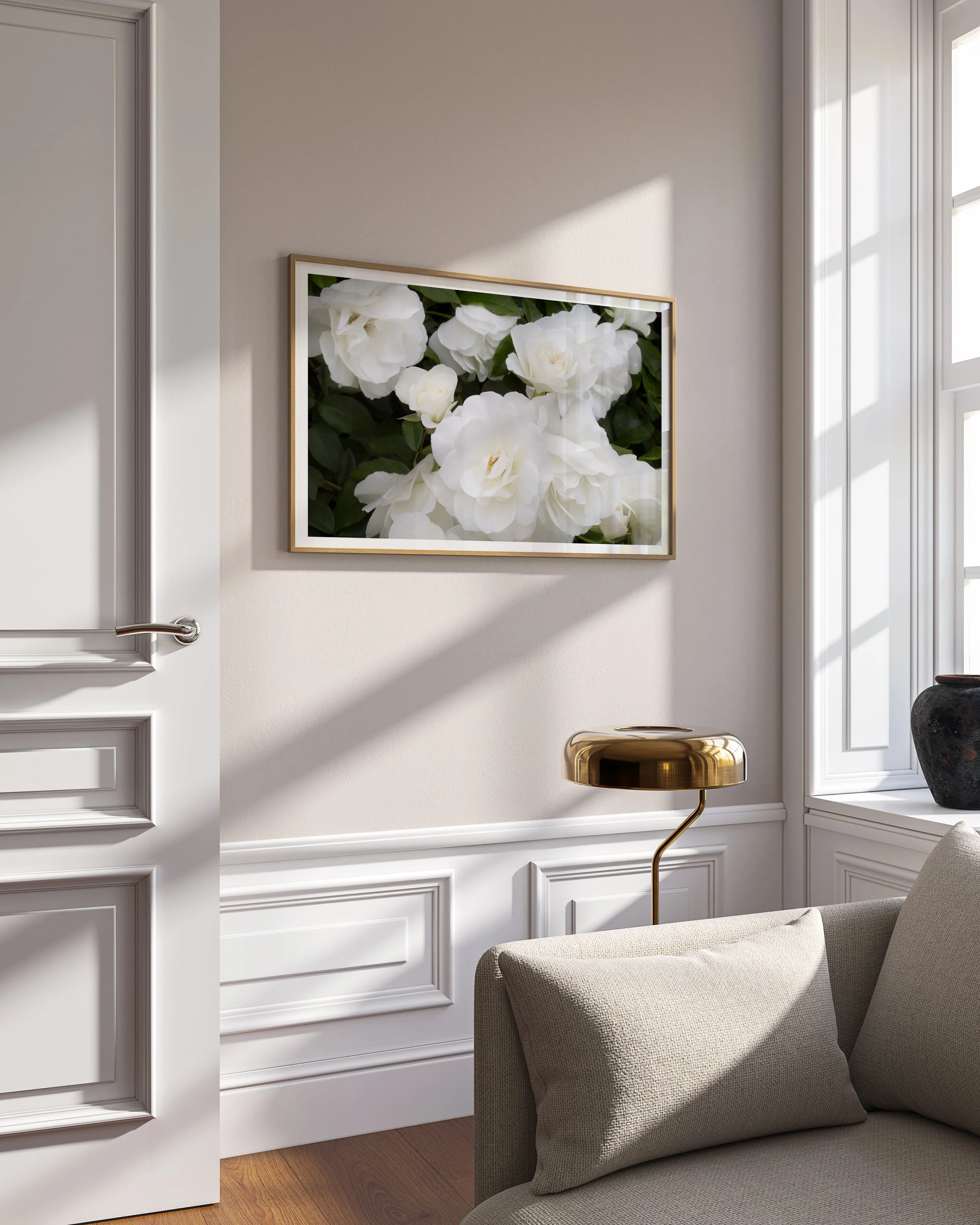 moody fine art photograph of white roses in frame on wall