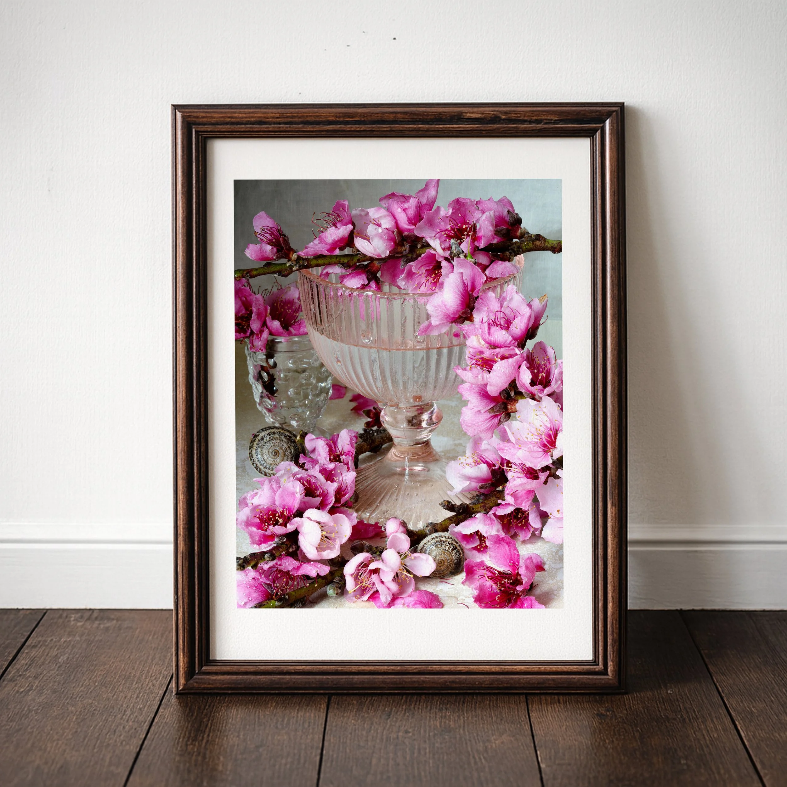Pink peach blossoms arranged in a modern studio still life with soft lighting and a minimalist fine art composition.
