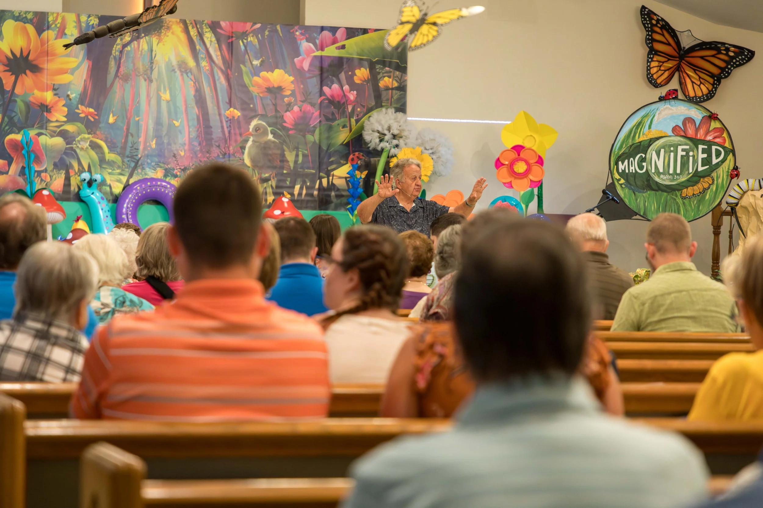 Open book on wooden table with sunlight.