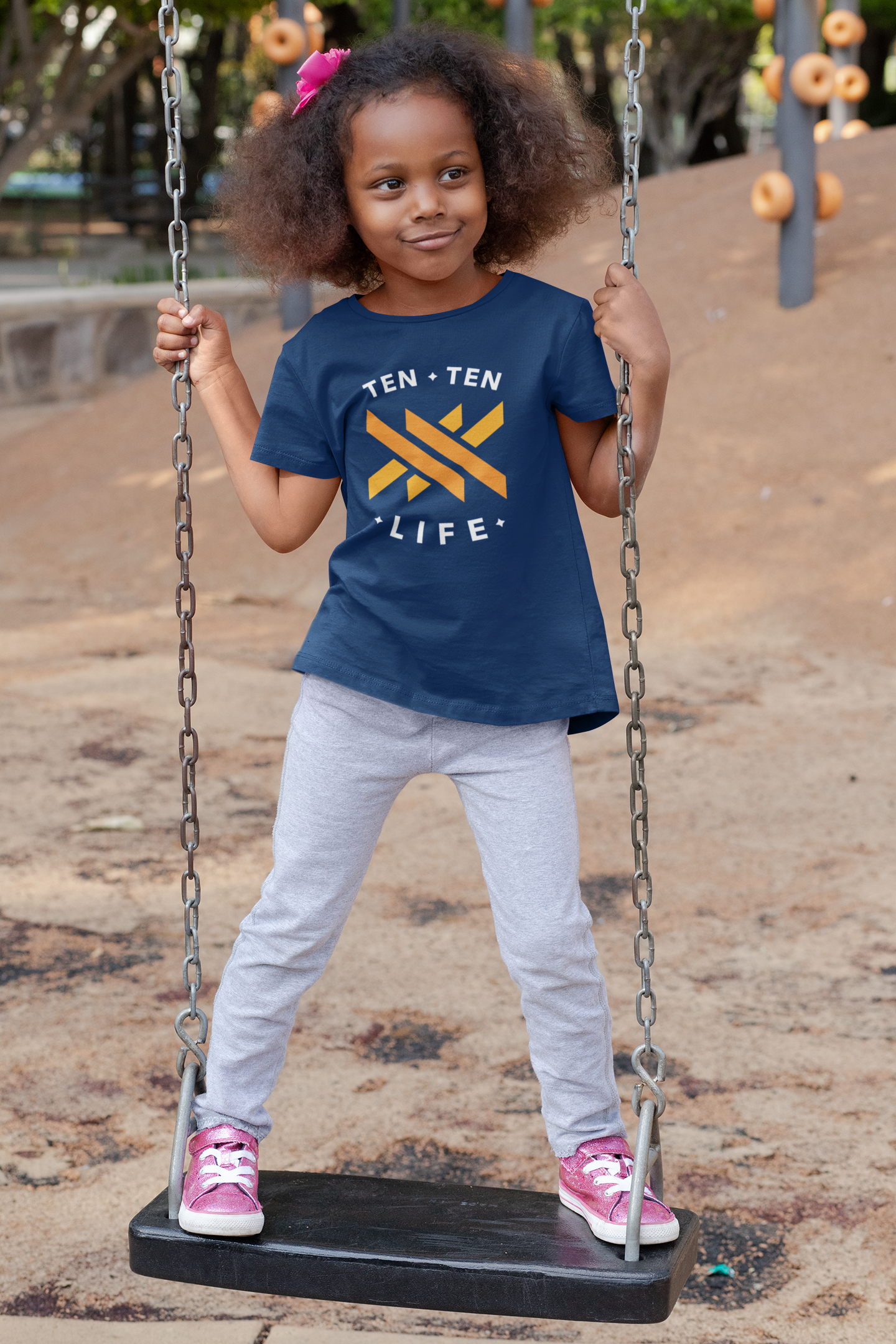t-shirt-mockup-of-a-playful-girl-standing-on-a-swing-32179.png