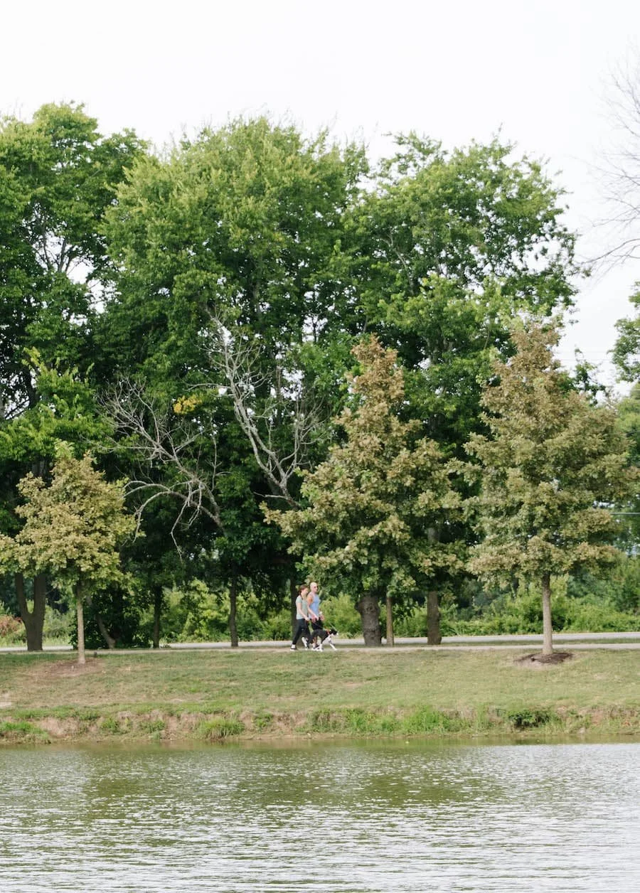 moving to tennessee pros and cons - couple walking a dog by water