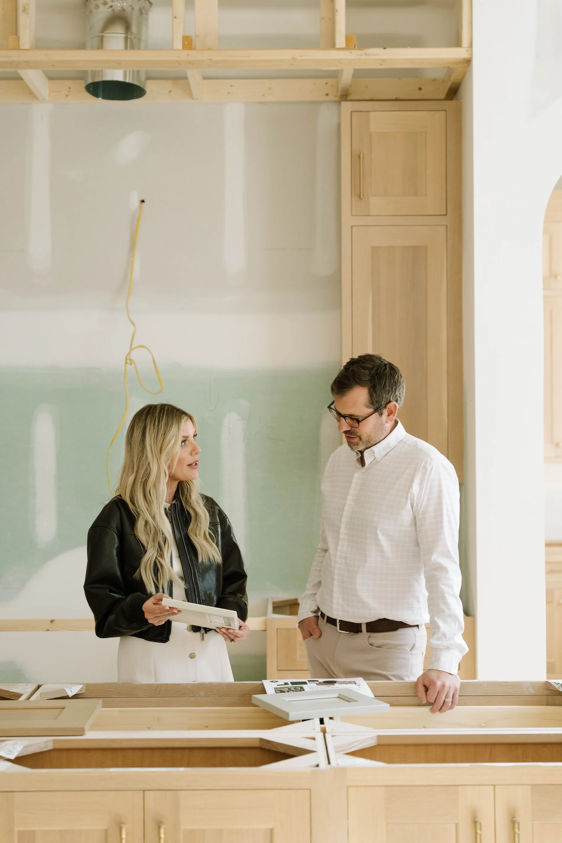 Nikki and Micah Zurich, of Zurich Homes, reviewing floor plans in an unfinished home
