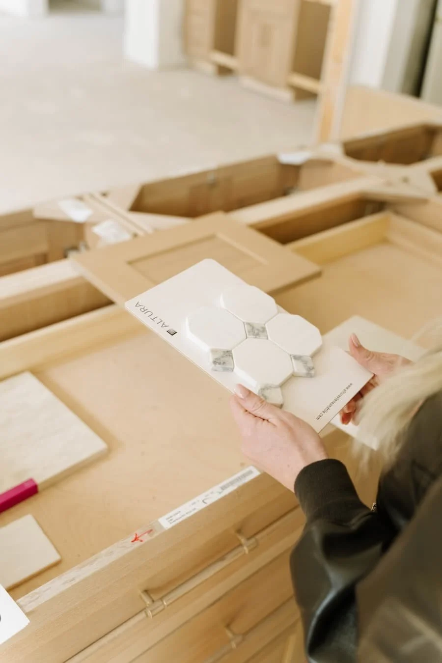 zurich homes - moving to tennessee checklist - woman's hands holding a tile sample in a home under construction