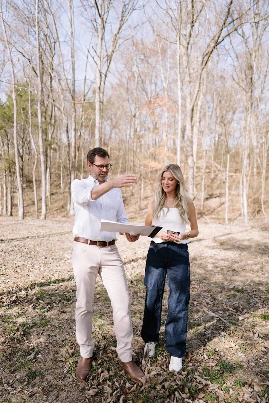 zurich homes - moving to tennessee checklist - two people standing on a plot of land looking at architectural plans