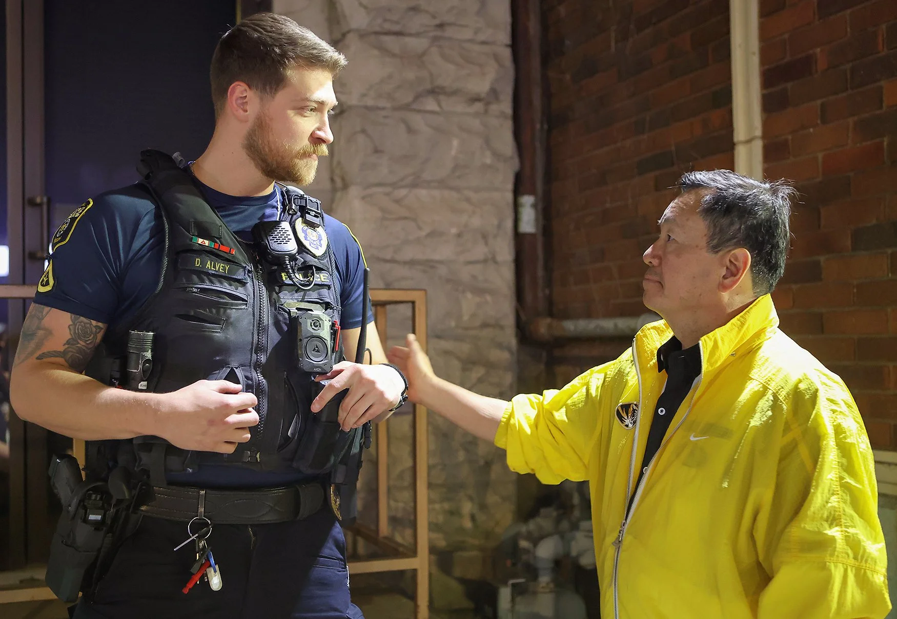 UM System President Mun Choi talks to officer Dalton Alvey on Saturday at Field House in downtown Columbia. “It is a complex issue, and when people talk about law enforcement and crime and accountability, they bring up root causes. They bring up disp