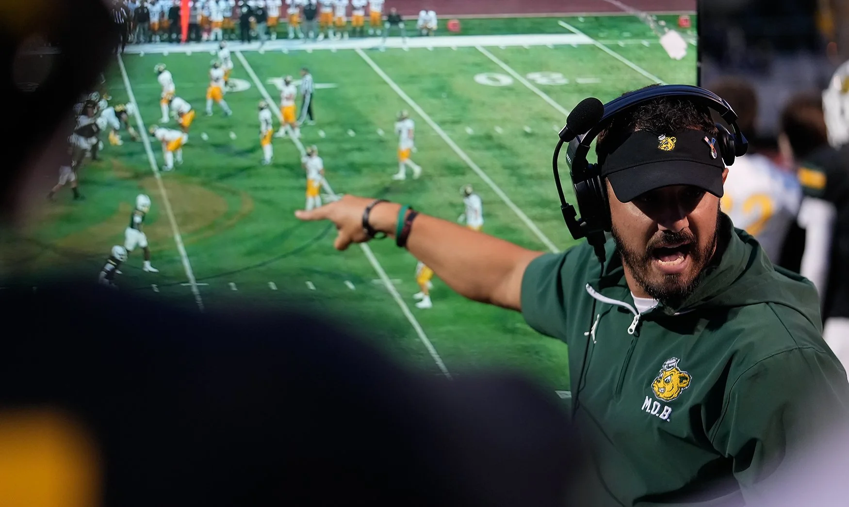 Rock Bridge assistant coach Chris Stehle explains film to his players during the first quarter of a game against Smith-Cotton on Friday at Rock Bridge High School in Columbia. The Bruins topped the Tigers 42-7 to move to 1-1.  Dan Murphy/Missourian