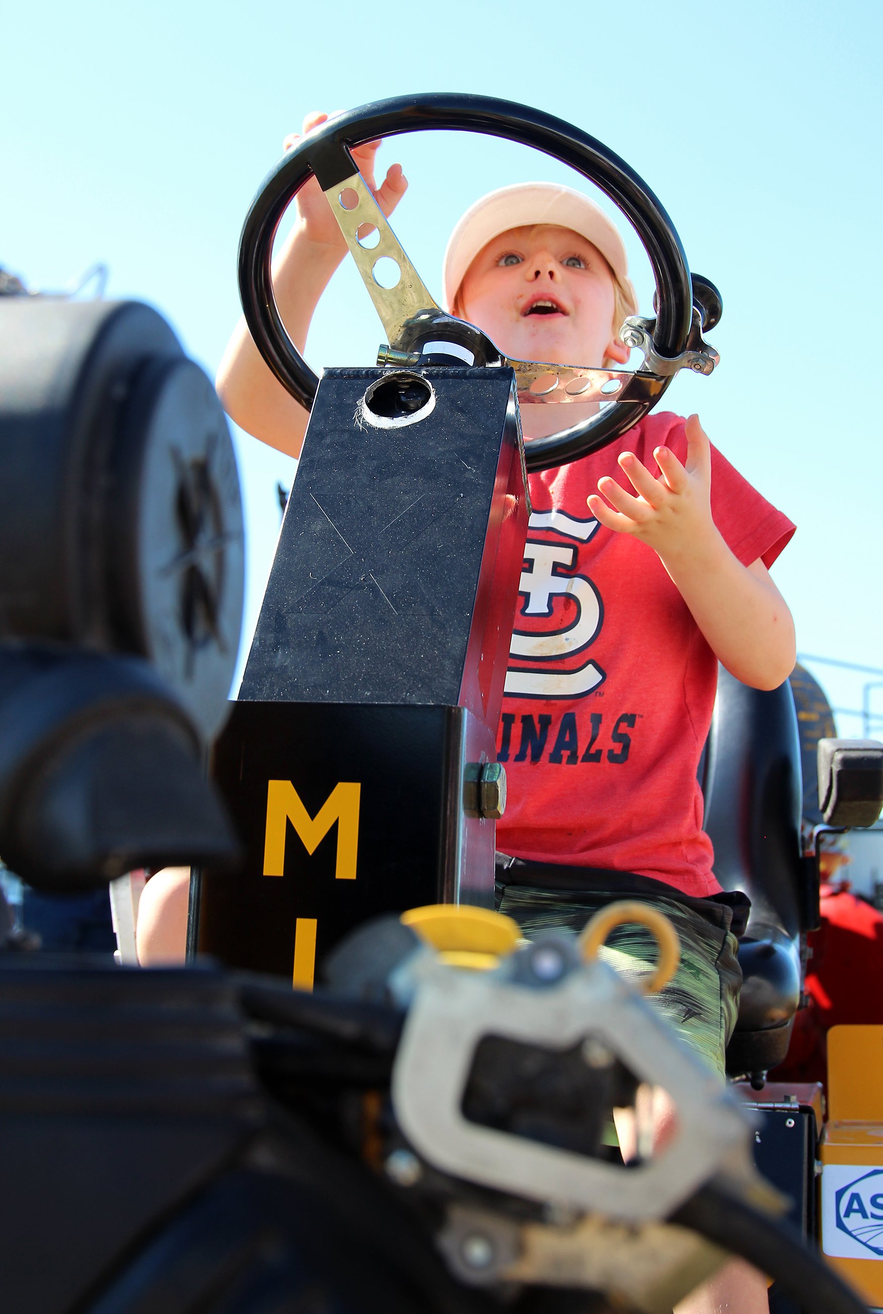 Carson Mitchell, 4, pretends to drive a tractor on Saturday at the Mizzou South Farm. The showcase brings in families for farm-themed activities.  Annie George/Missourian