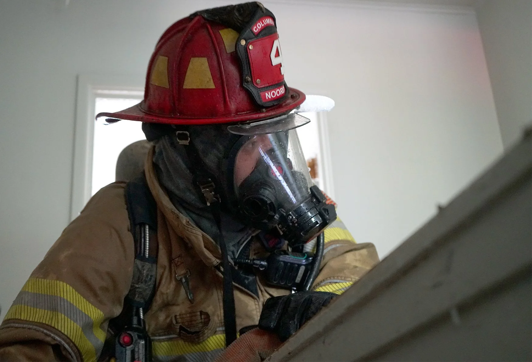 Capt. Shawn Noordsy watches as a fire hose expands through the apartment on Sept. 16 at Park Avenue Apartments. Noordsy was practicing clearing out rooms. Maverick Dillon/Missourian