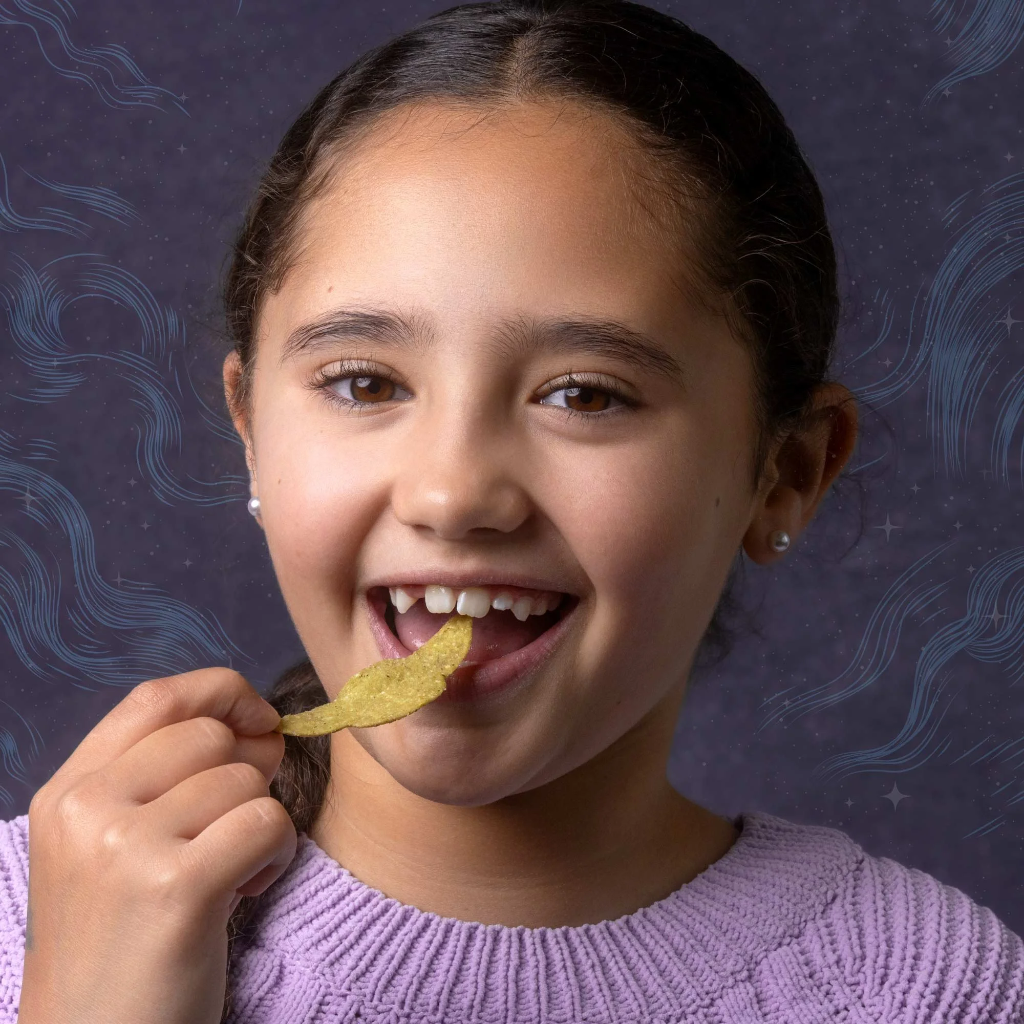 A young girl with brown eyes and dark hair, smiling and holding a potato chip near her mouth. She is wearing a purple knitted sweater and earrings, with a dark background featuring blue wave and star illustrations.
