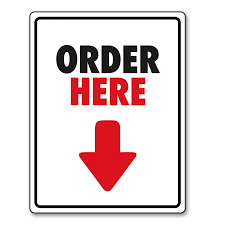 Sign with bold text reading 'Order Here' and a downward arrow.