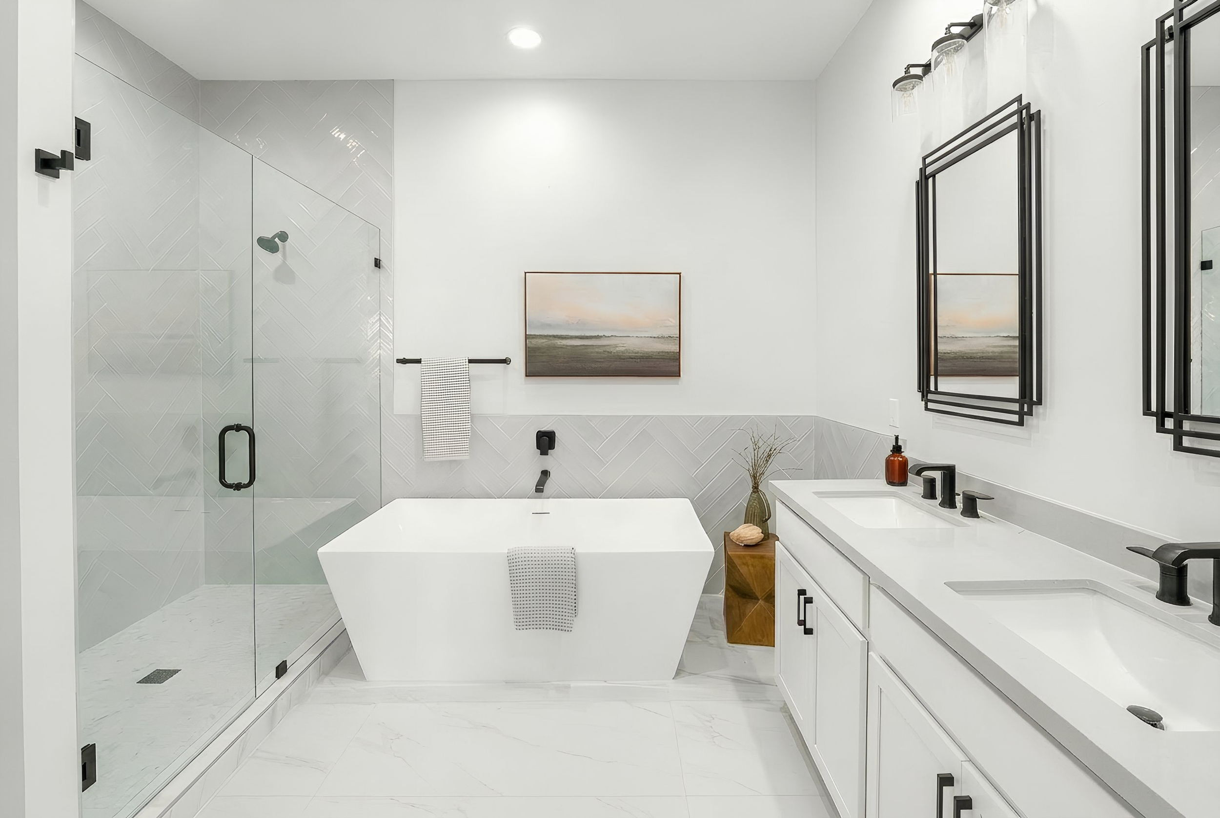 Modern bathroom with a walk-in shower, freestanding bathtub, double vanity with black fixtures, and minimal decor.