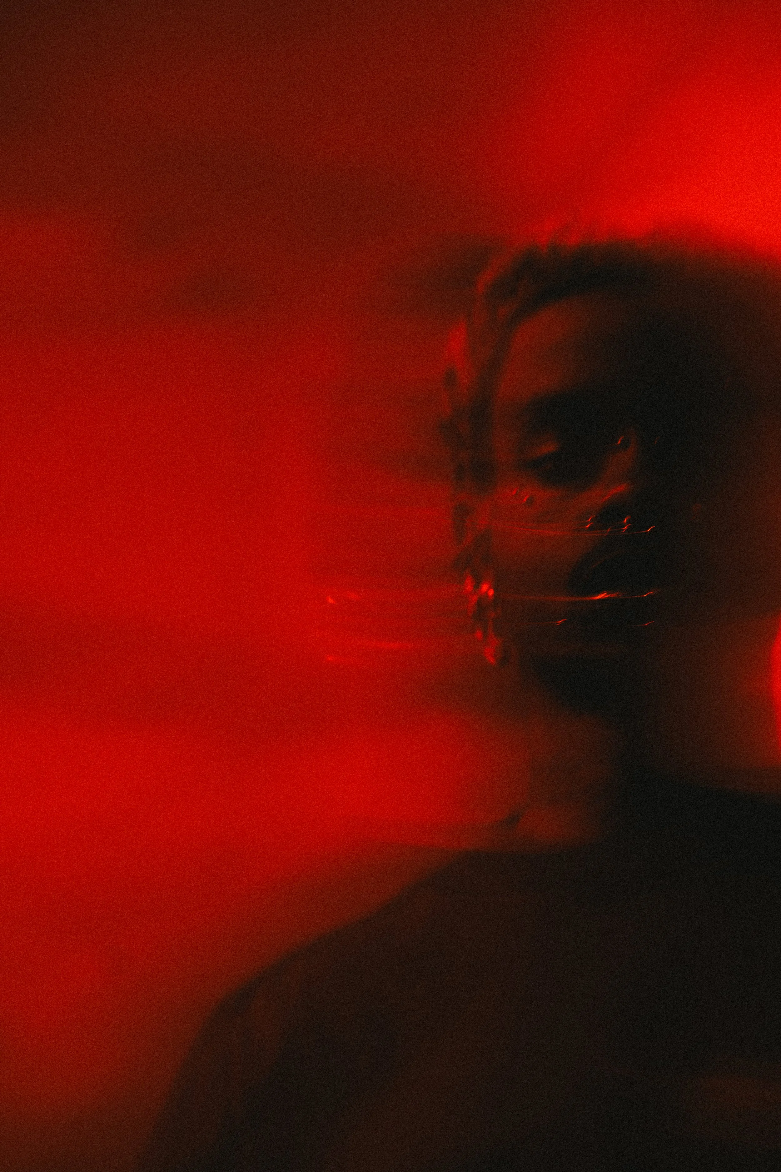 Blurred silhouette of a person against a red background