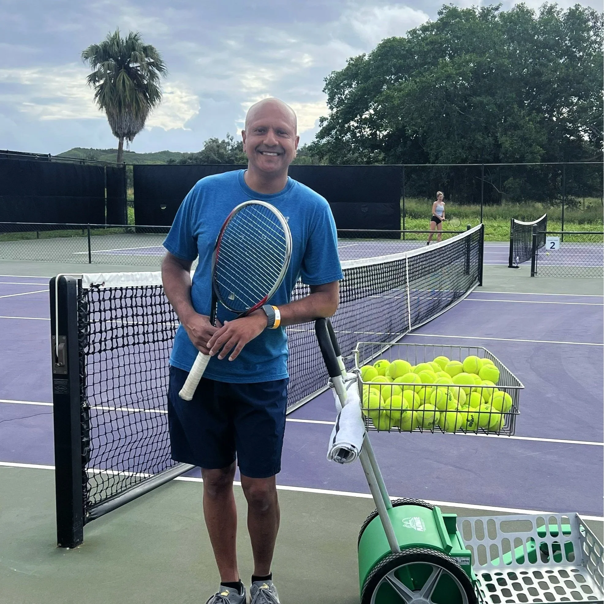 Ramneek Bhogal professor playing tennis after chiropractic gut health seminar.  Doing a masters degree