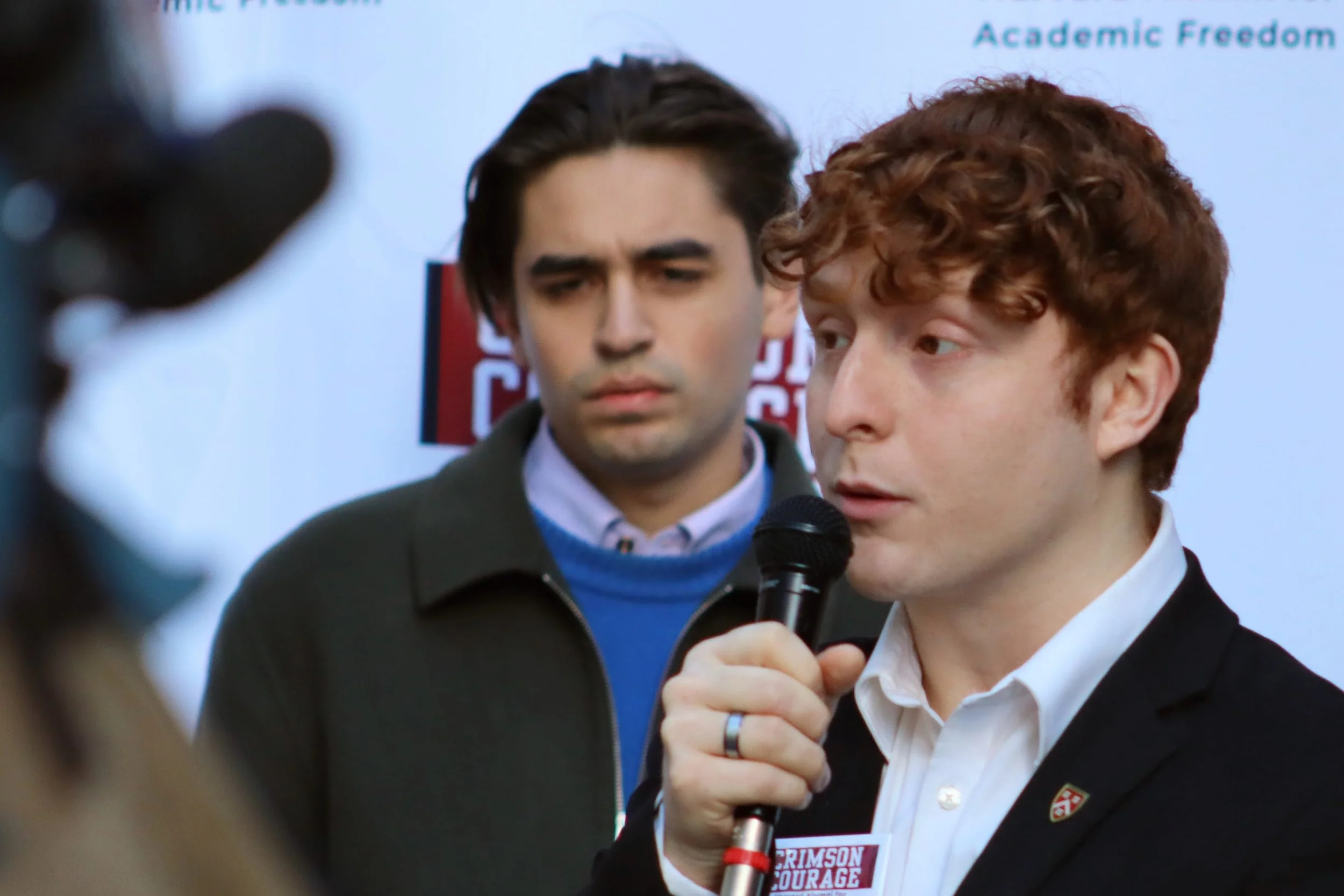       
  
    Foreground: Daniel Noguer, Harvard undergraduate and President of Students for Freedom, speaking outside the Moakley Courthouse in Boston  Background: Karl Molden, Harvard undergraduate from Vienna, Austria and Co-Founder of Students fo