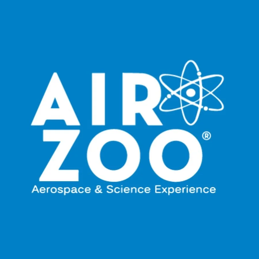 Blue background with white text that reads 'AIR ZOO' and a tagline 'Aerospace & Science Experience,' with an atomic model graphic.