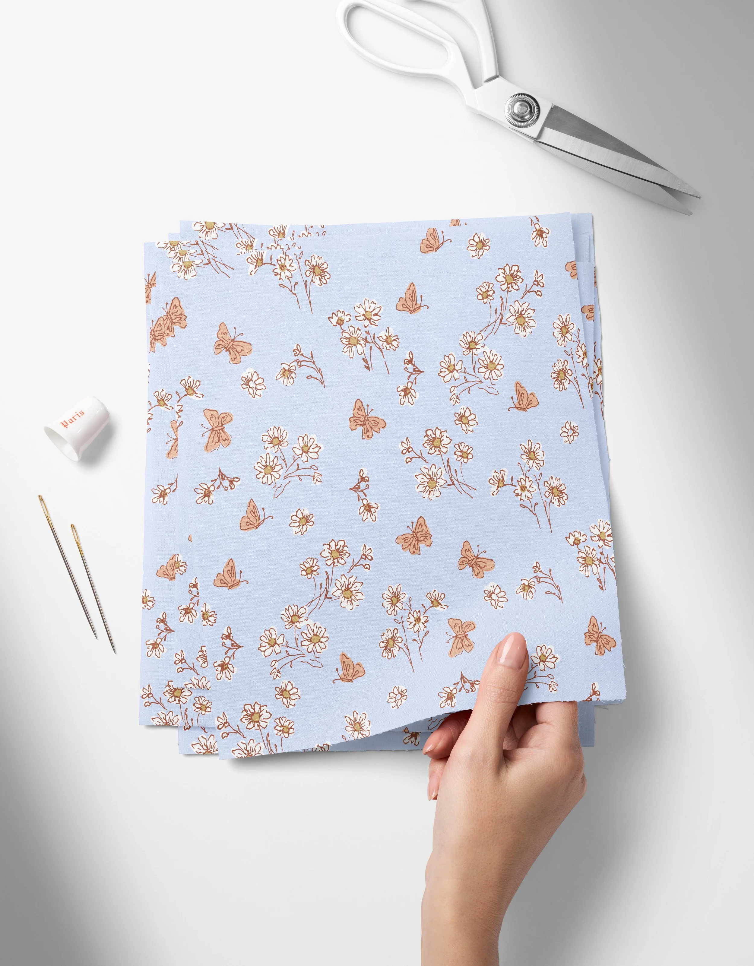 Daisies-blue-01-01_Top View of Fabric Swatches Held in Hand Mockup by Creatsy®.jpg