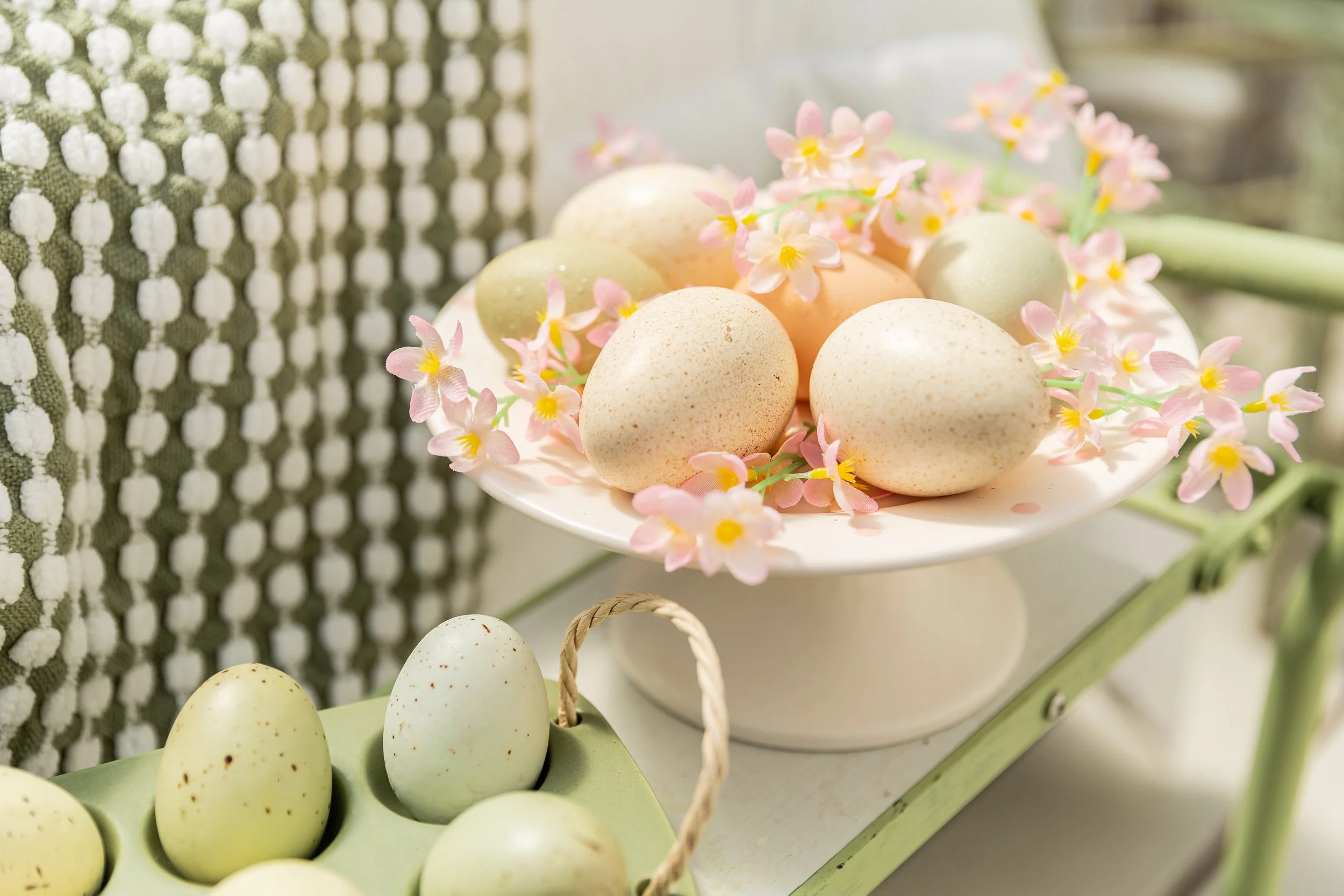 Farm eggs with pink flowers in a decorative arrangement