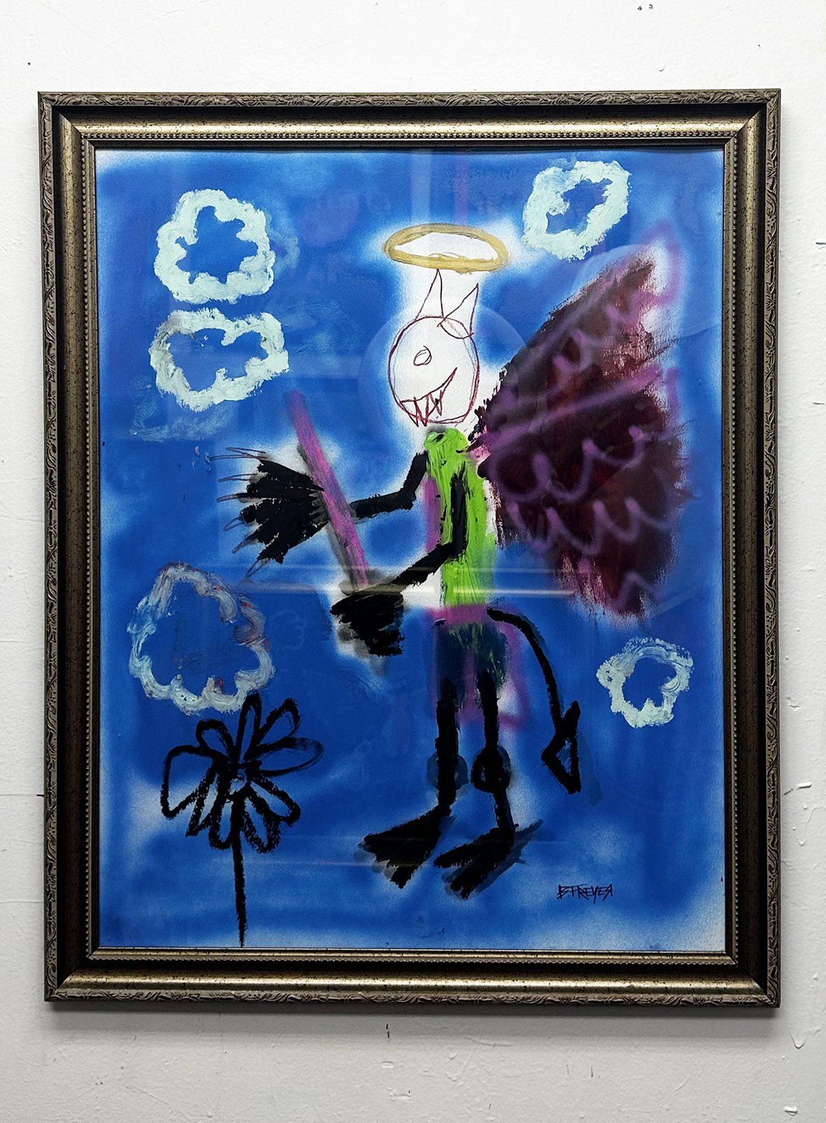 Framed abstract artwork featuring a whimsical figure with wings, a halo, and a devil tail on a blue background with cloud-like shapes.