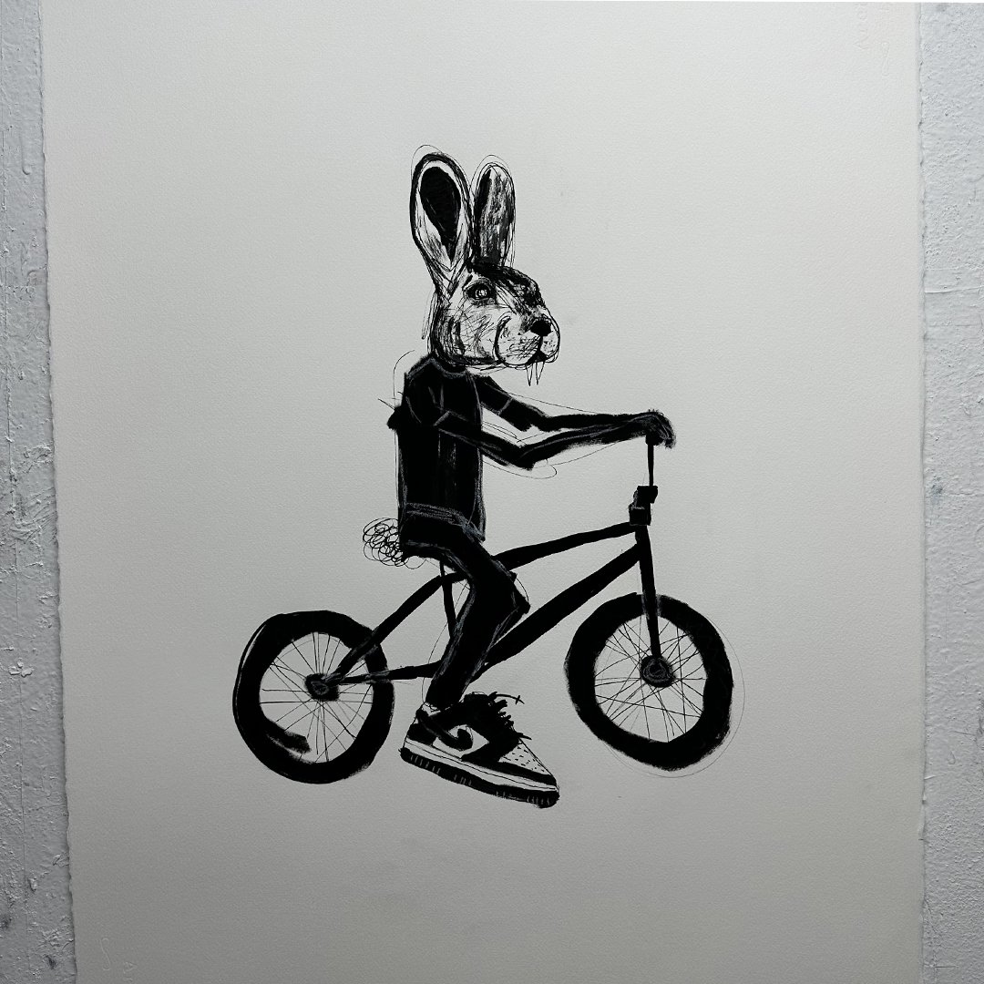 Illustration of a rabbit-headed figure riding a bicycle in black and white.