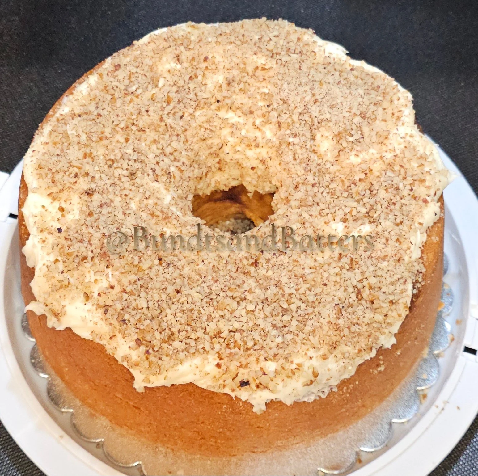Cinnamon Roll Pound Cake with Cream Cheese Frosting and Chopped Pecans