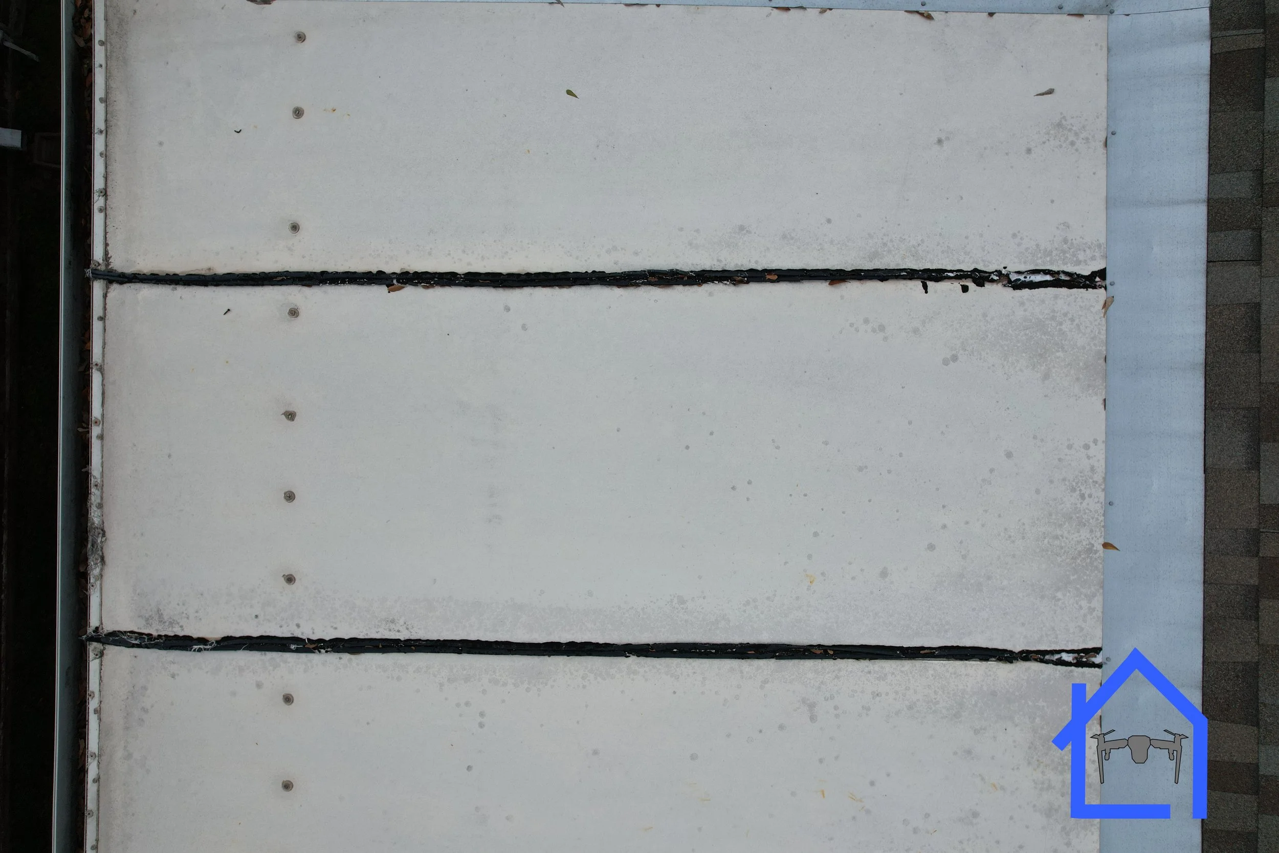 Aerial nadir drone view of a white patio roof installed by the homeowner.