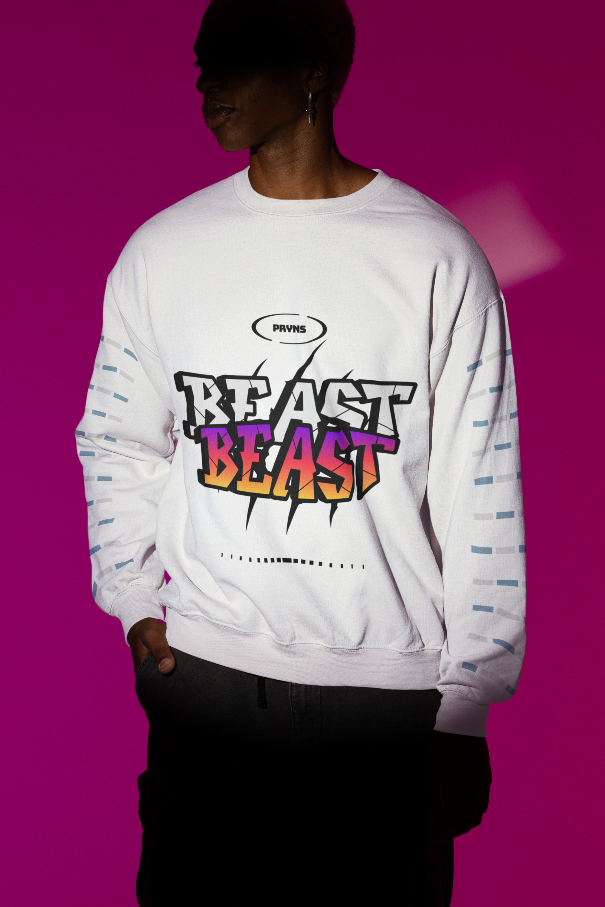 Person wearing a white sweatshirt with colorful 'BEAST' graphic, standing against a purple background.