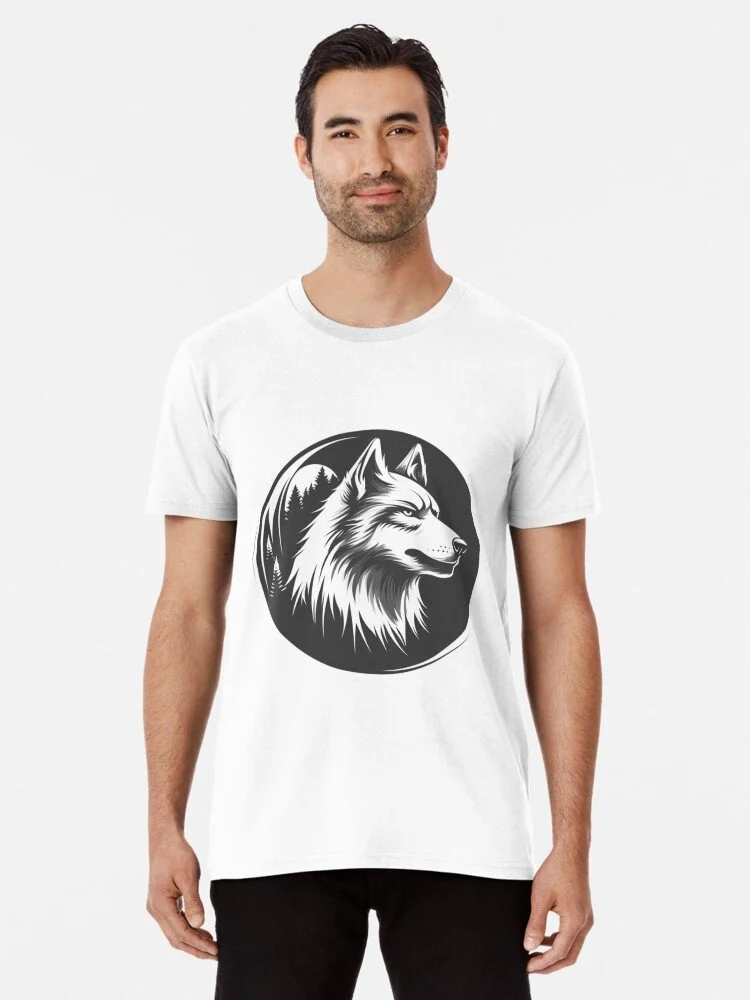 A man wearing a white T-shirt with a black graphic of a wolf's head in front of a forest background.
