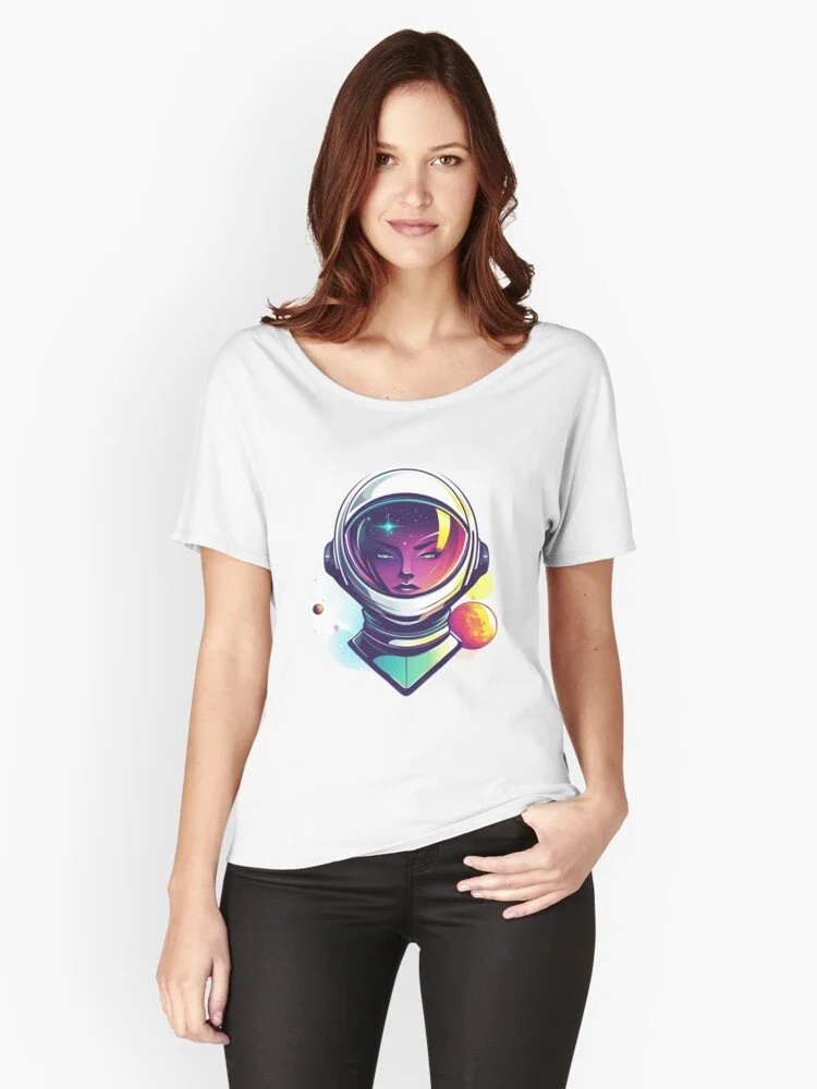 A woman wearing a white t-shirt with a graphic of a female astronaut with purple skin, wearing a helmet, and planets in the background.