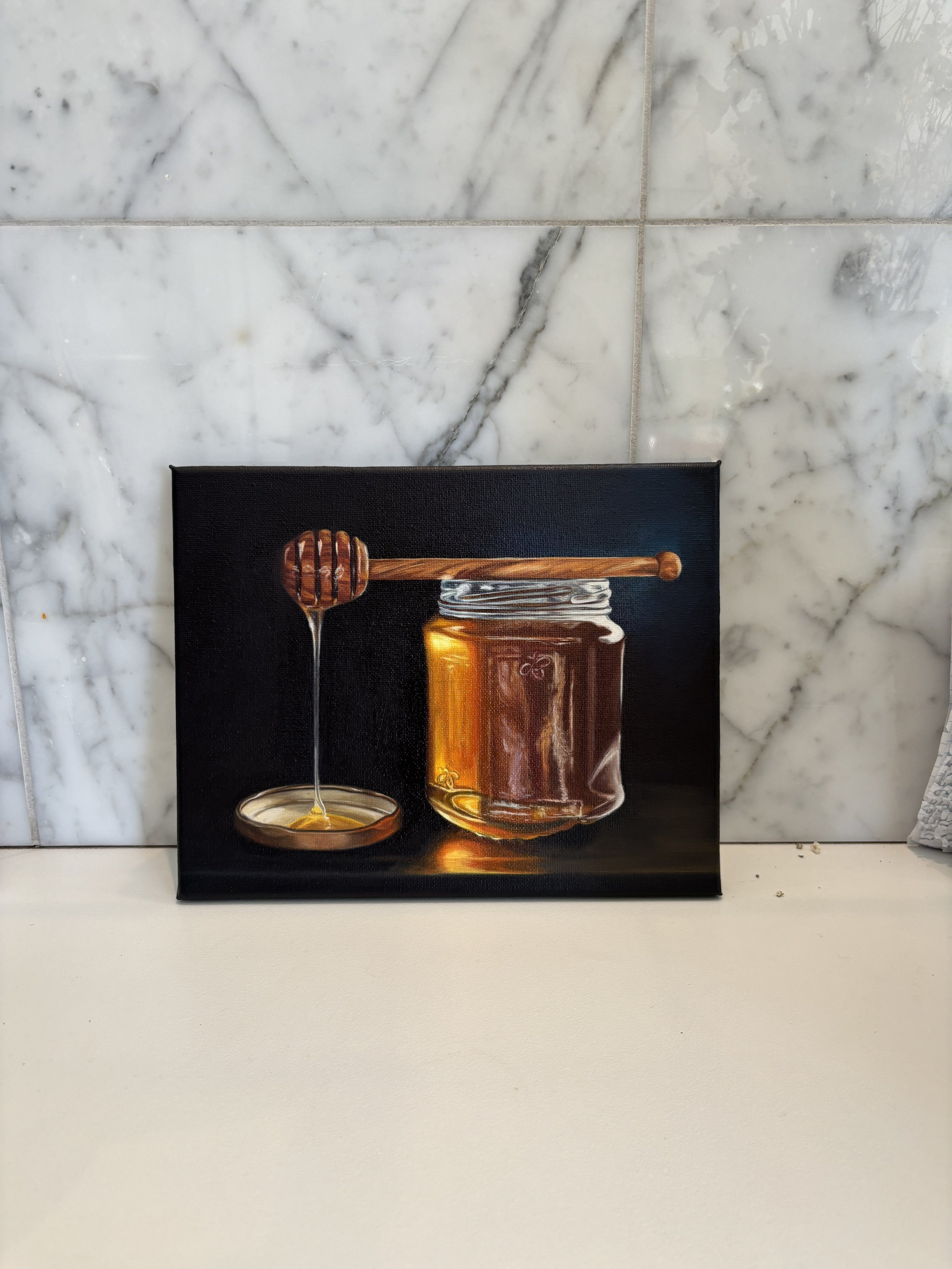 Painting of a honey jar with a honey dipper and honey dripping into a small dish, set against a dark background.