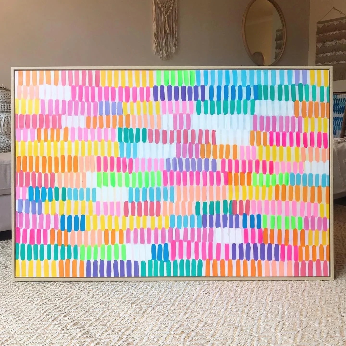Colorful mosaic artwork with small, rounded rectangular shapes in various bright colors arranged in a grid pattern.