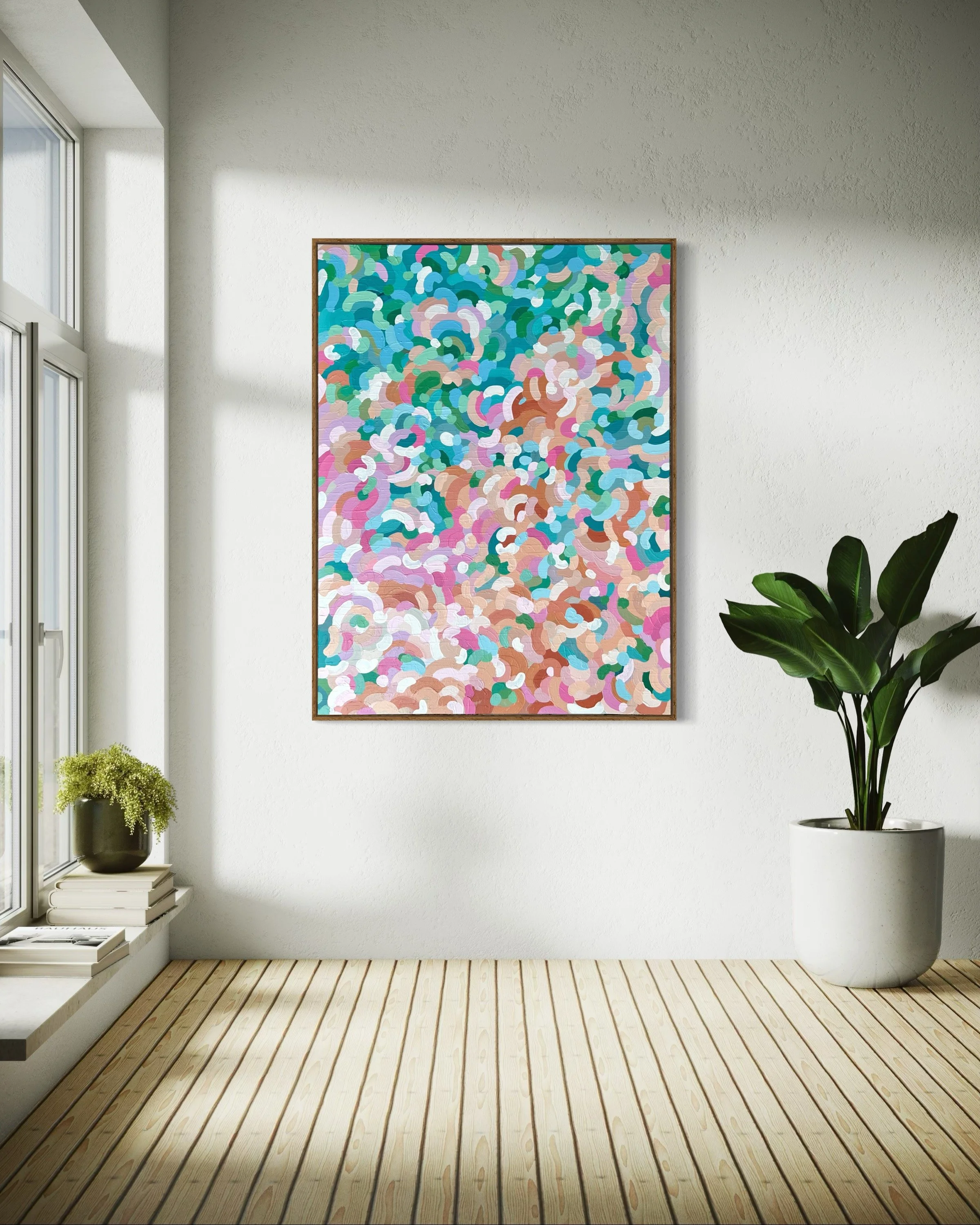 Sunlit room with a large colorful abstract painting on the white wall, a large potted plant on the right, a window with a small plant and books on the left, and wooden floorboards.