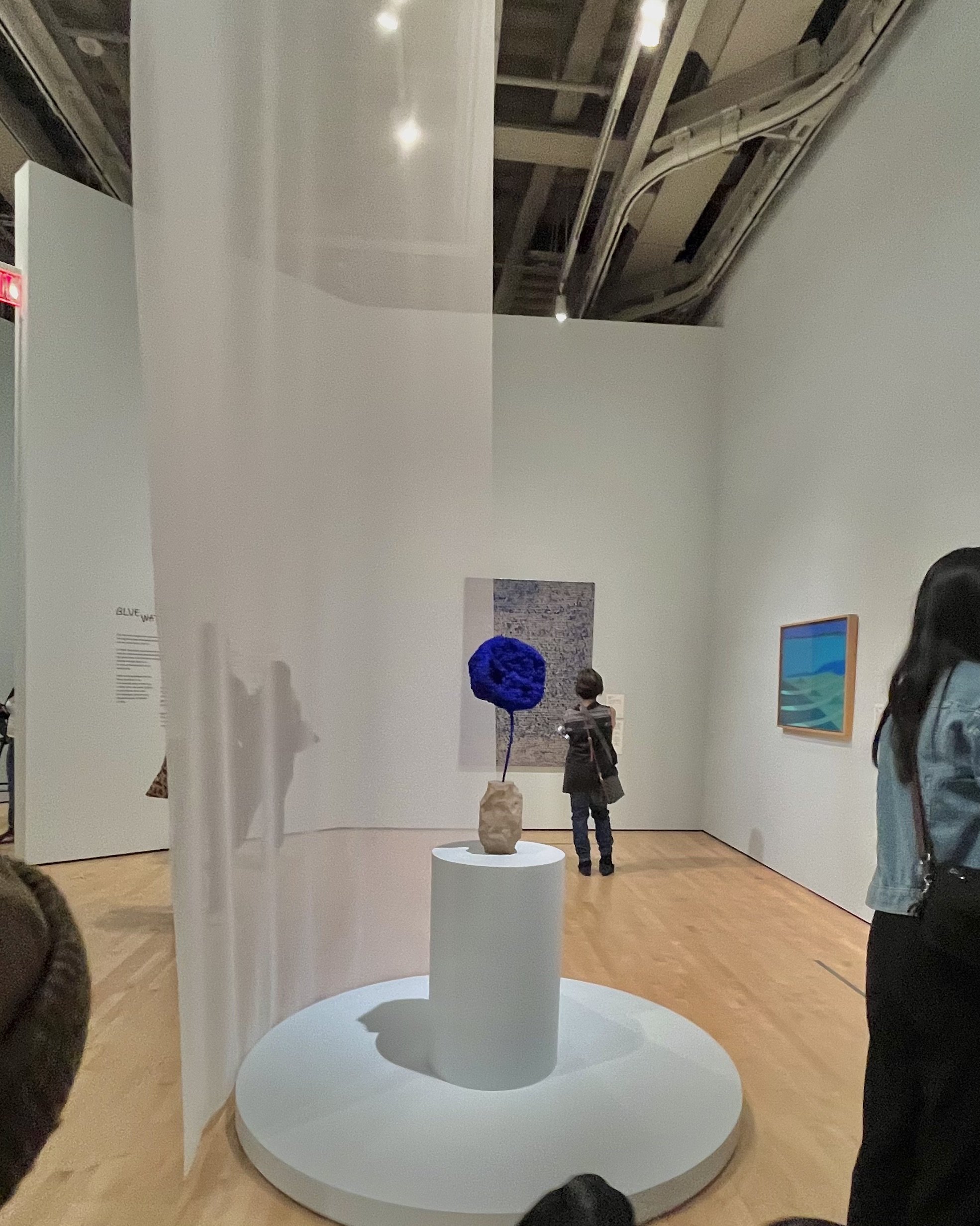  Yves Klein,  Éponge (SE251) (Sponge [SE 251])  (1961), with Kim Whanki's  26-I-70 #141  (1970) in the background. SFMOMA. Photography © The Noun. 