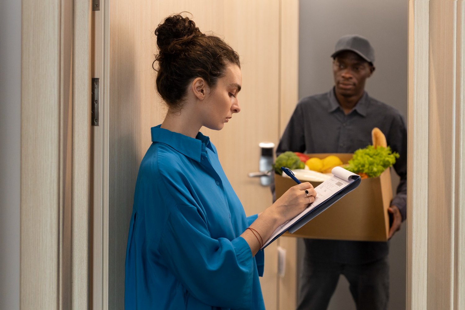 women-checking-grocery-list-board-on-hand.jpg