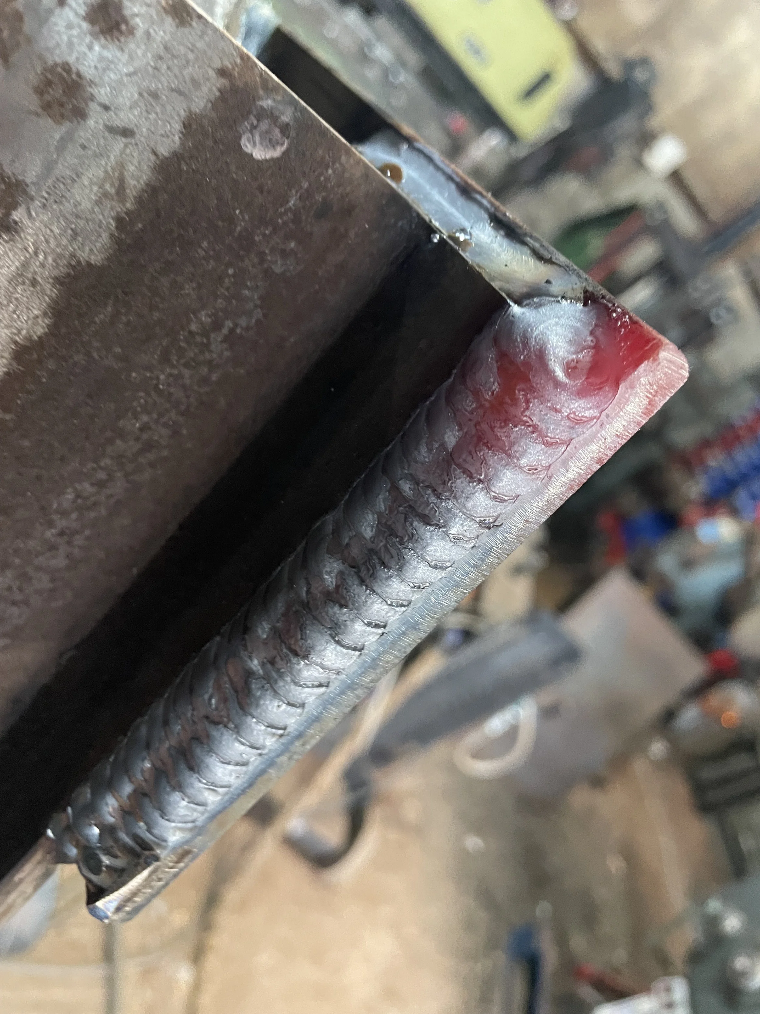 Uphill mig Welded metal corner joint with visible weld beads.
